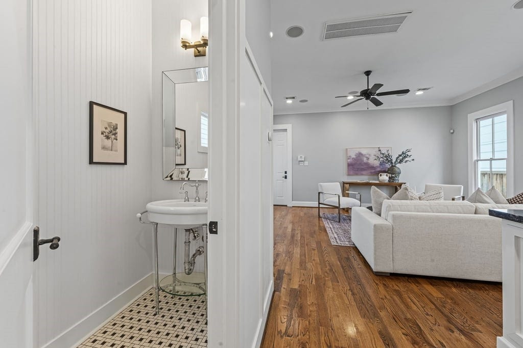 Convenient first-floor powder bath with a classic pedestal sink and distinctive patterned tile.