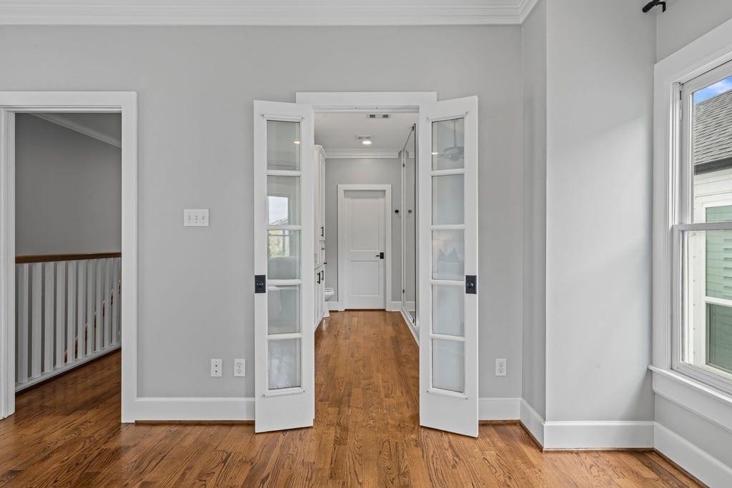 Elegant French doors and traditional millwork add character to the upstairs interior.