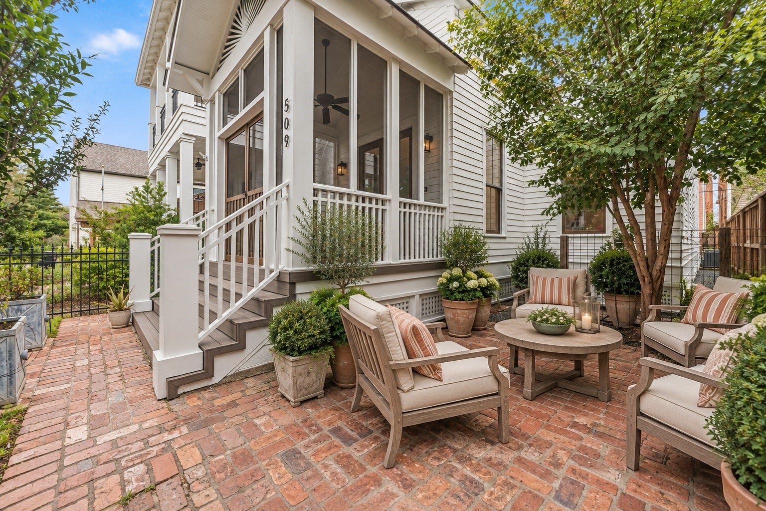 Screened porch overlooking the brick courtyard offers a peaceful extension of the home's living spaces.
