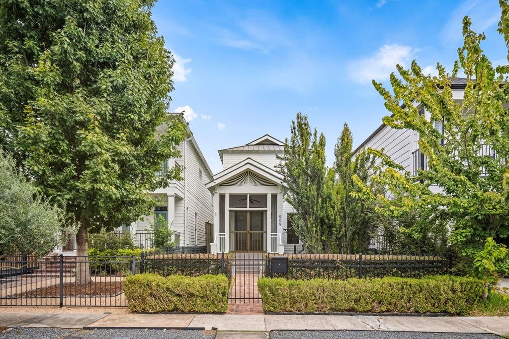 Welcome to 509 E 26th St. Timeless Craftsman architecture framed by mature landscaping in the heart of Sunset Heights.
