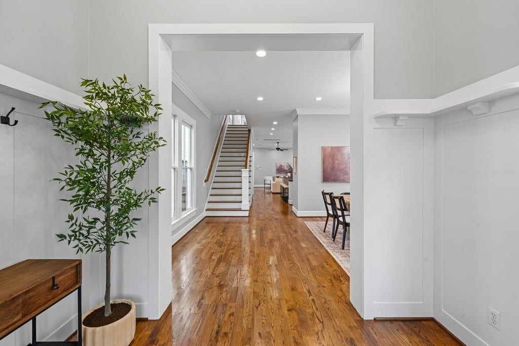 Gracious entry with rich hardwood flooring, high ceilings, and an inviting view into the home.