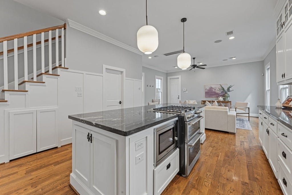 Thoughtfully designed kitchen with abundant cabinetry, integrated cooktop, and stylish pendant lighting.