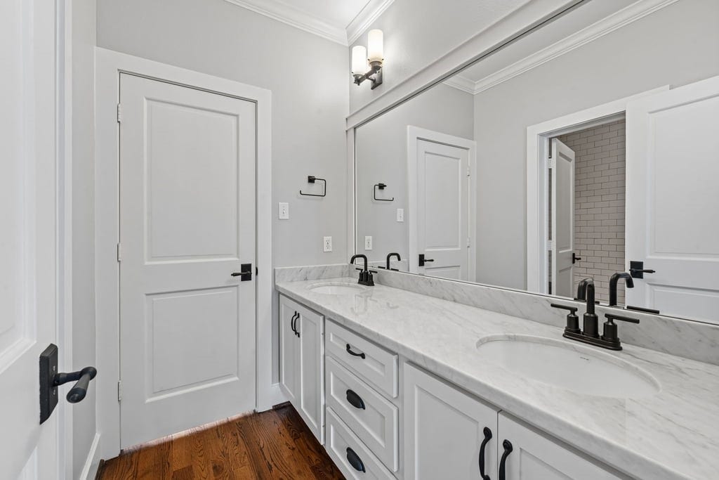 A second perspective of the shared bath highlights generous counter space and dual sinks.