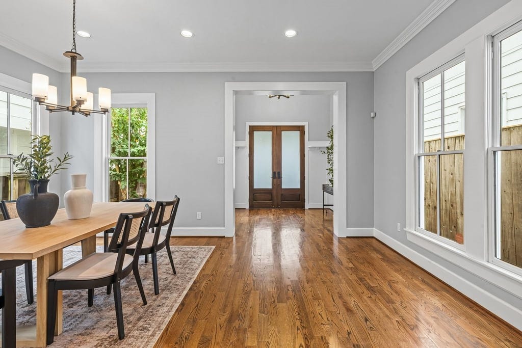 Expansive formal dining room filled with natural light and accented by elegant architectural trim.