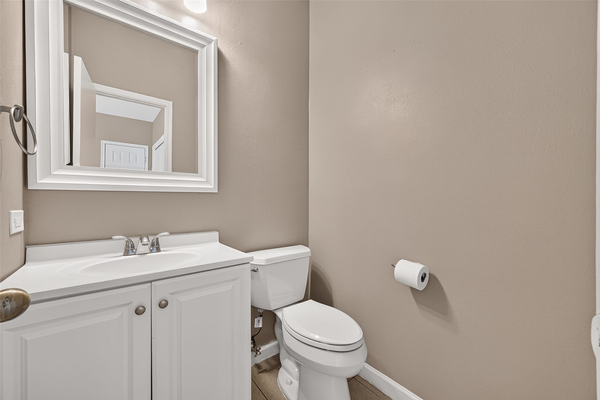 2930 Grants Lake Boulevard, #2202, Sugar Land, TX 77479 Convenient half bath featuring a bright vanity, framed mirror, neutral finishes, and easy access for guests.