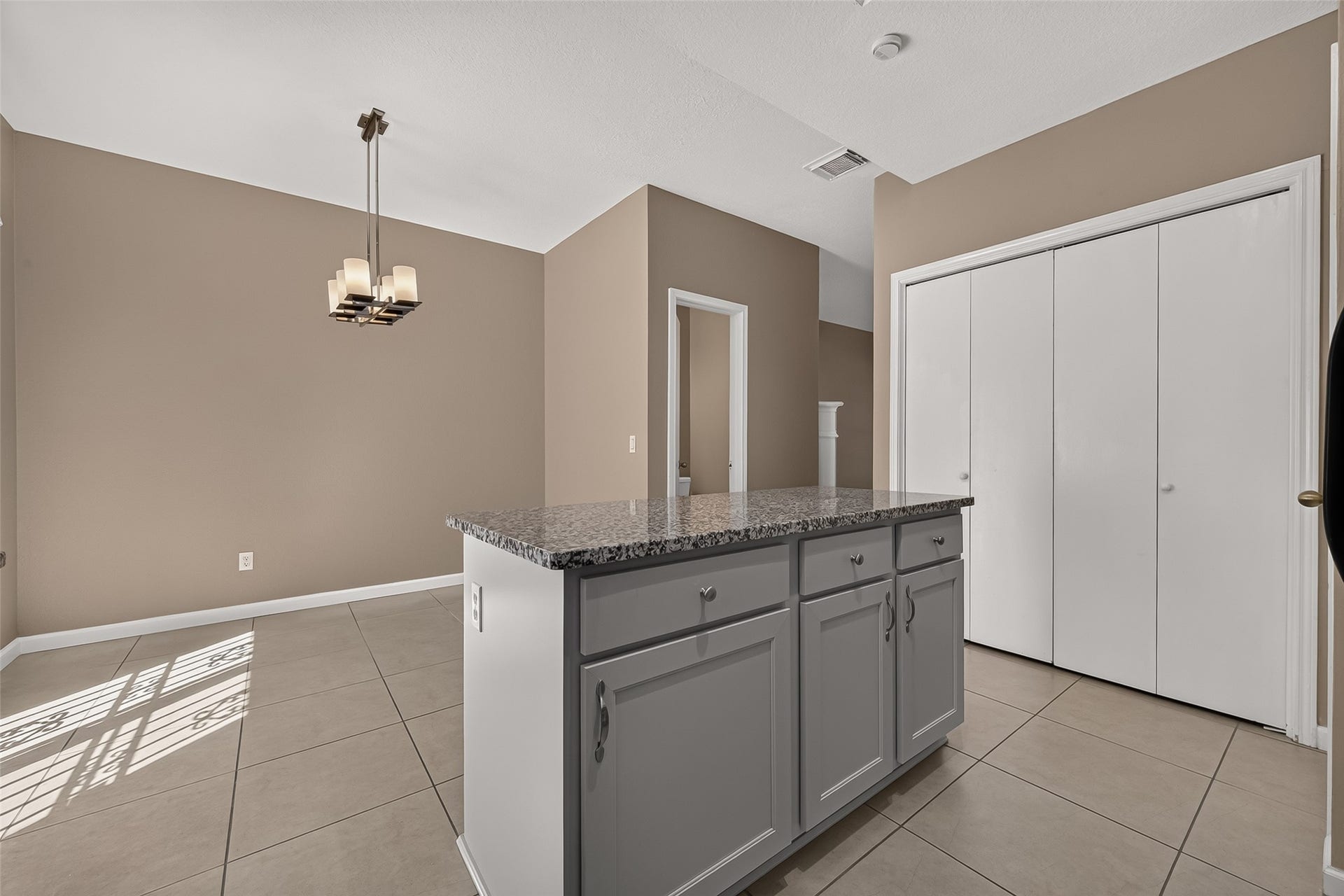2930 Grants Lake Boulevard, #2202, Sugar Land, TX 77479 Open dining area adjacent to the kitchen with granite-topped island, generous storage, neutral finishes, and modern lighting.