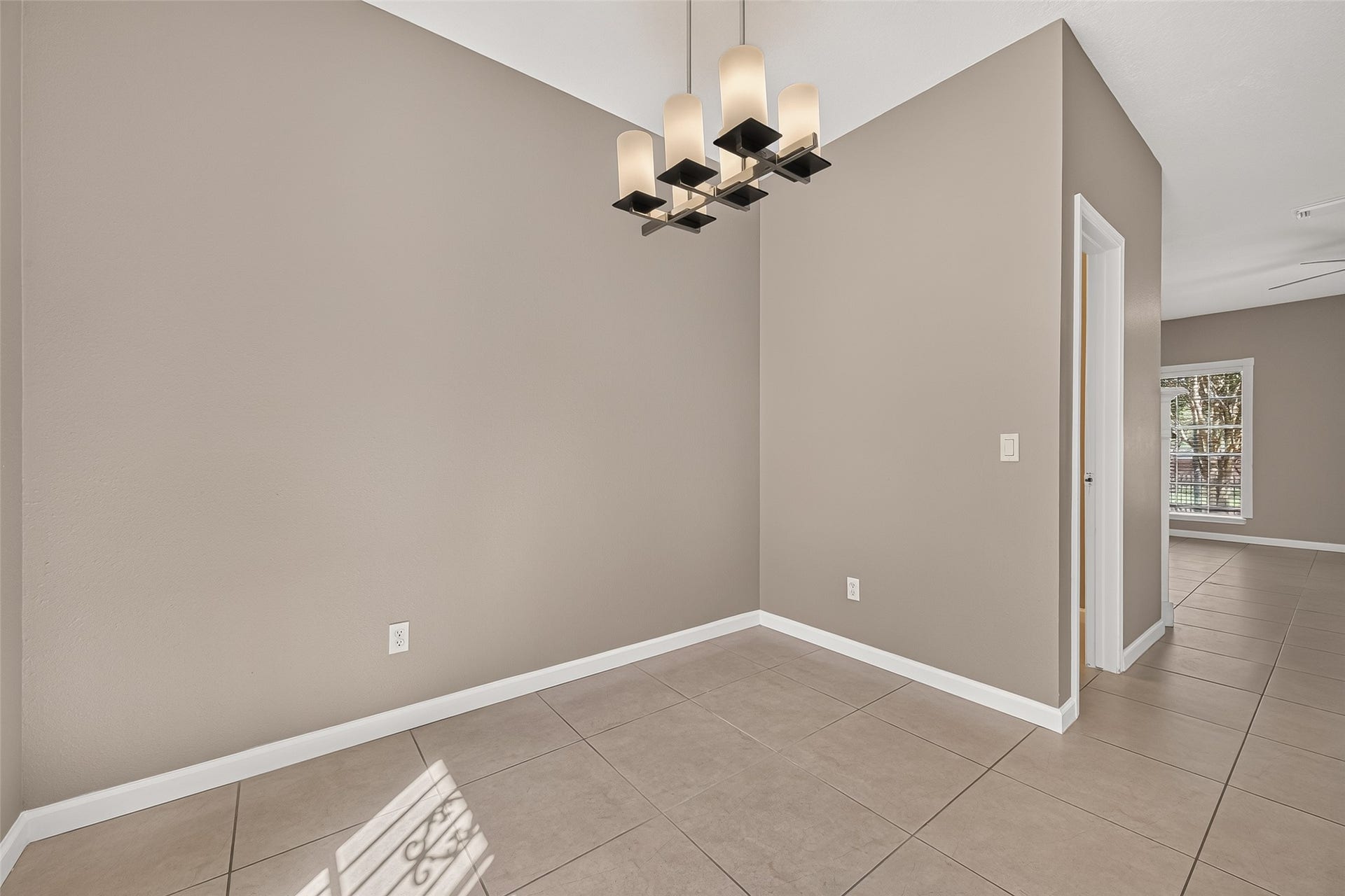 2930 Grants Lake Boulevard, #2202, Sugar Land, TX 77479 Dedicated dining area with tile flooring, neutral finishes, contemporary chandelier, and convenient access to the kitchen and living areas.