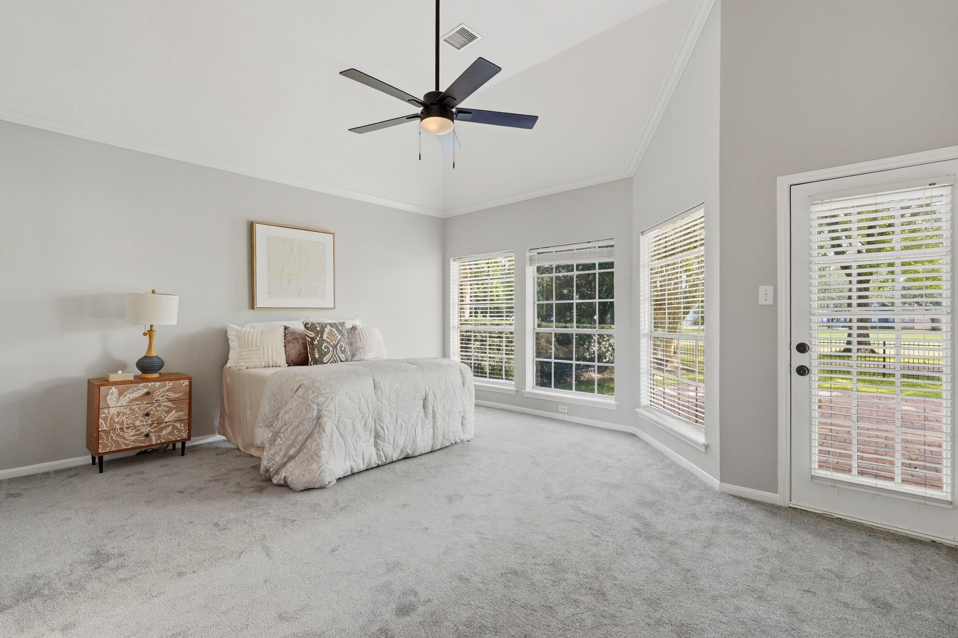 Primary retreat with new carpet and private exterior door to the patio.