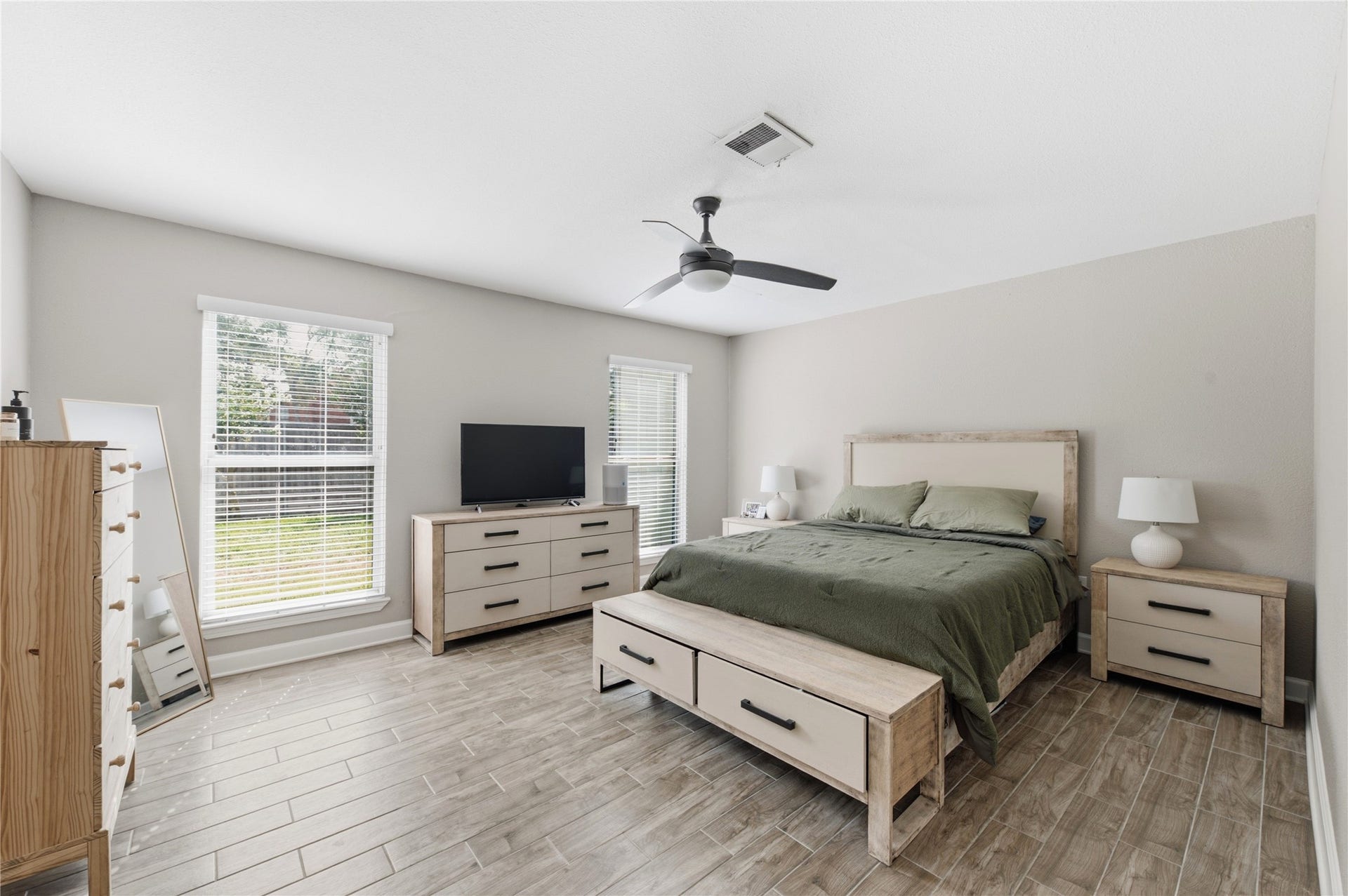 2211 Kinbrook Drive, Houston, TX 77077 Spacious primary bedroom retreat with bright windows.
