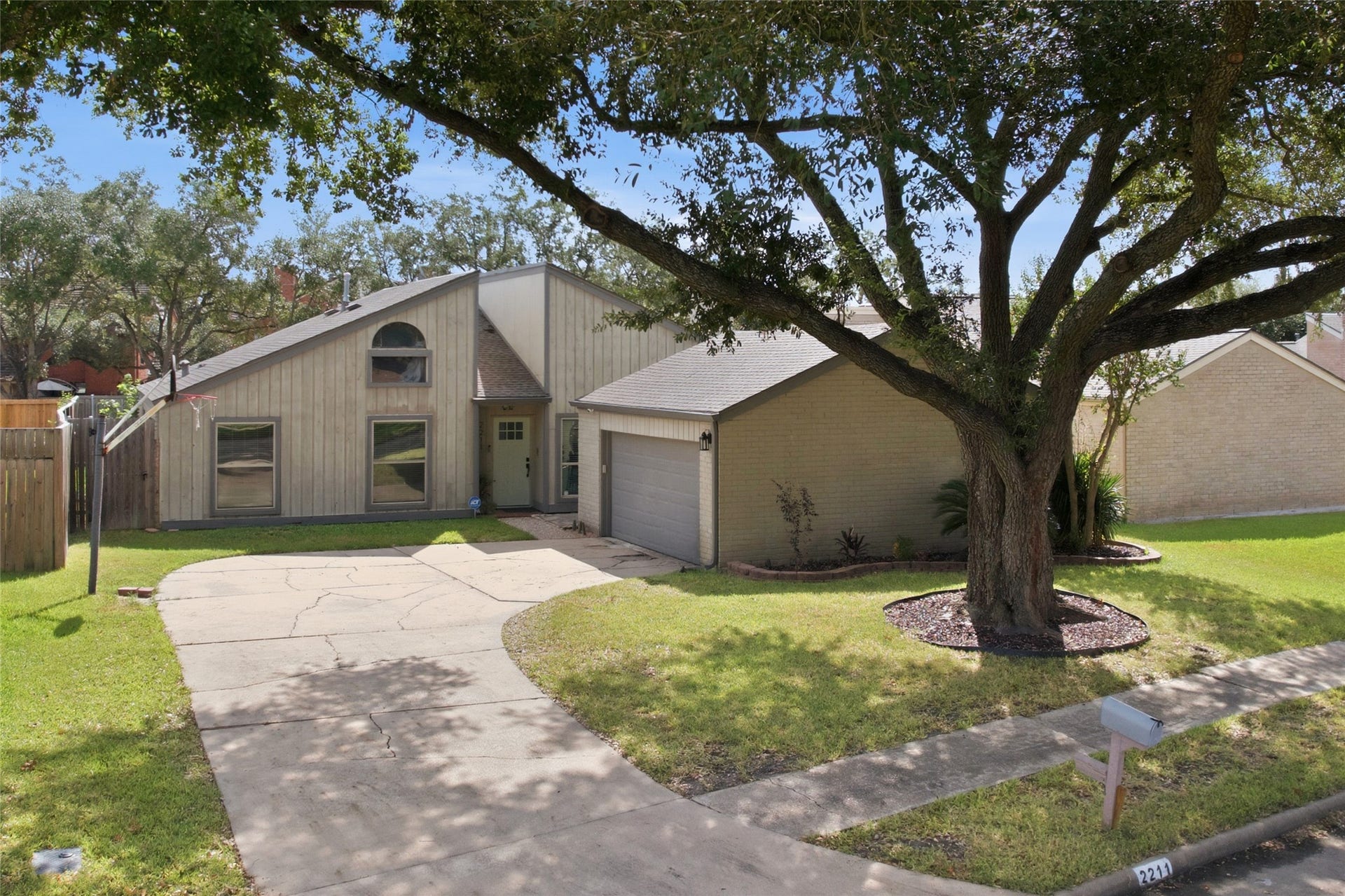 2211 Kinbrook Drive, Houston, TX 77077 Long driveway leads to a two-car garage, providing plenty of parking space.