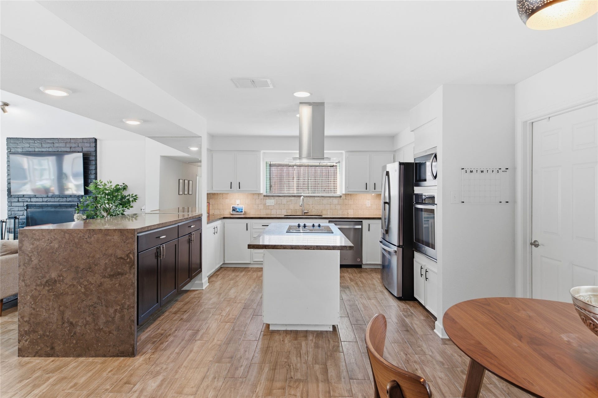 2211 Kinbrook Drive, Houston, TX 77077 Stainless steel appliances and an island featuring an electric cooktop with hood make cooking a breeze!