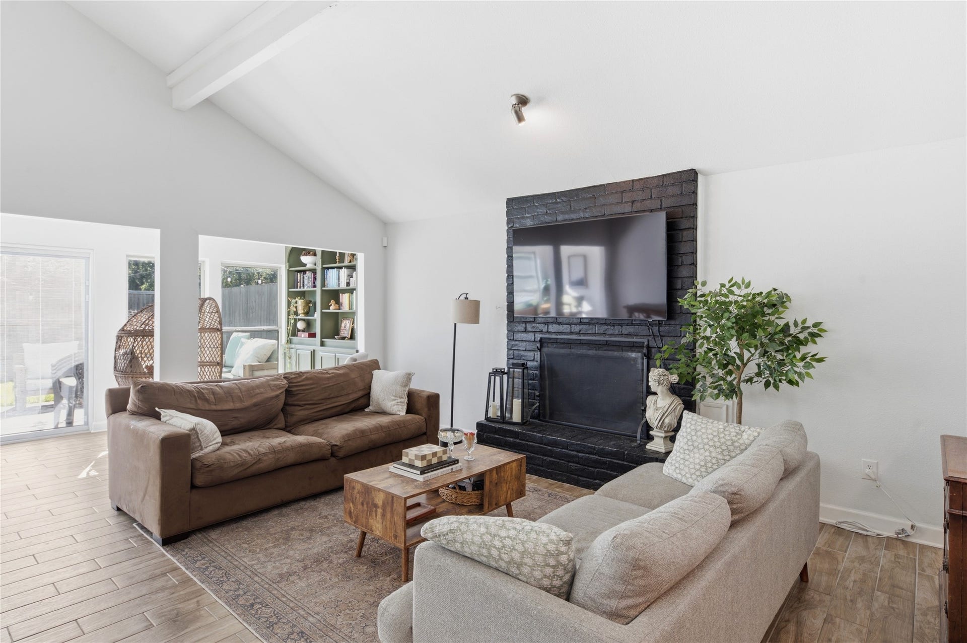 2211 Kinbrook Drive, Houston, TX 77077 Spacious living room centered around a cozy fireplace.