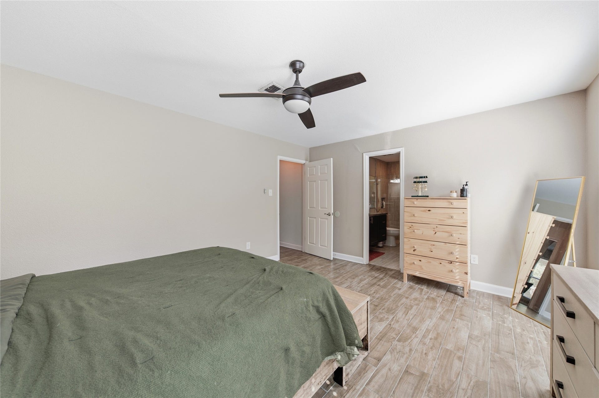 2211 Kinbrook Drive, Houston, TX 77077 The primary bedroom features an en-suite full bath and walk-in closet.