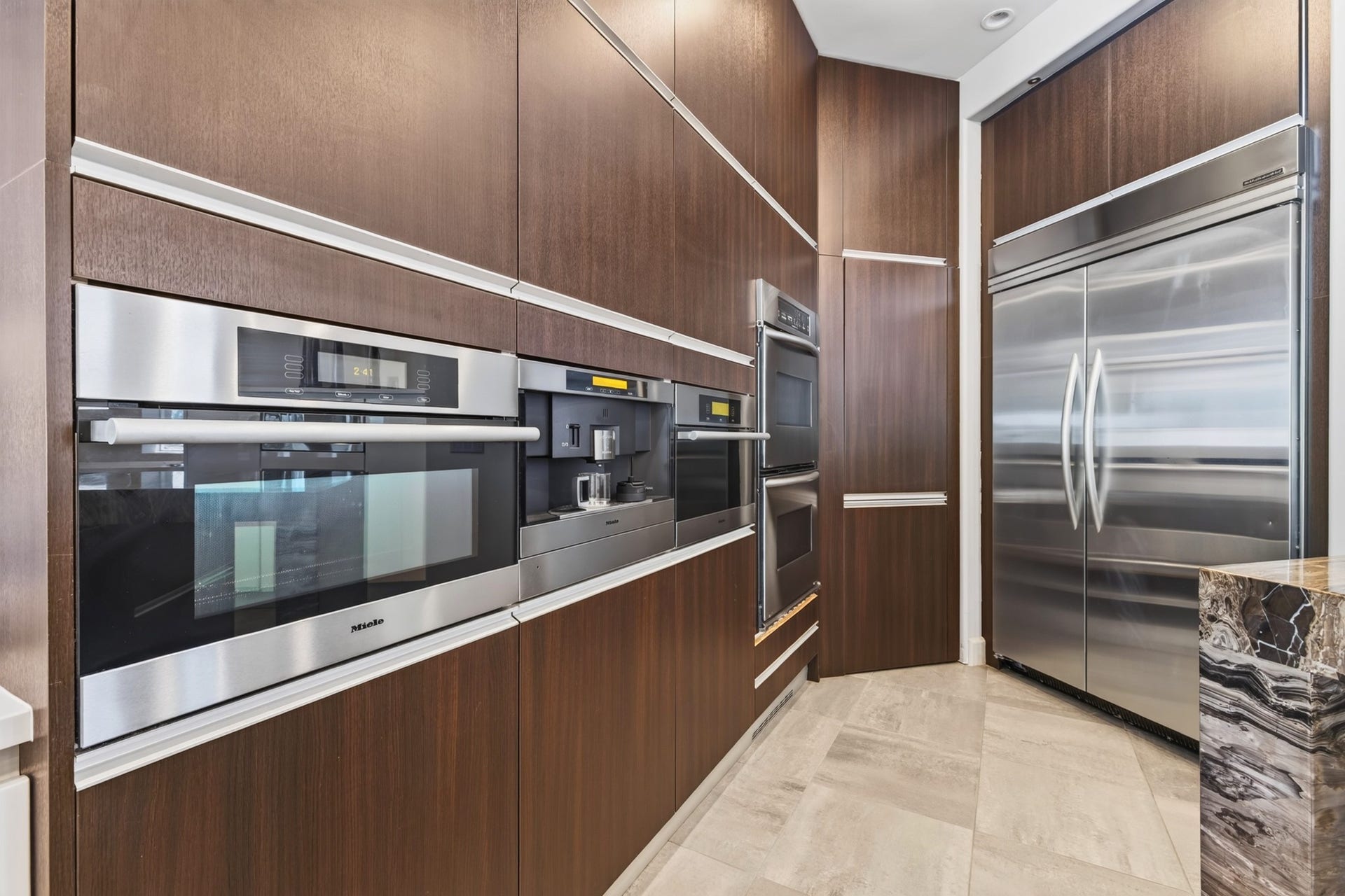 Integrated appliance wall and extensive custom cabinetry complement the sophisticated kitchen design.