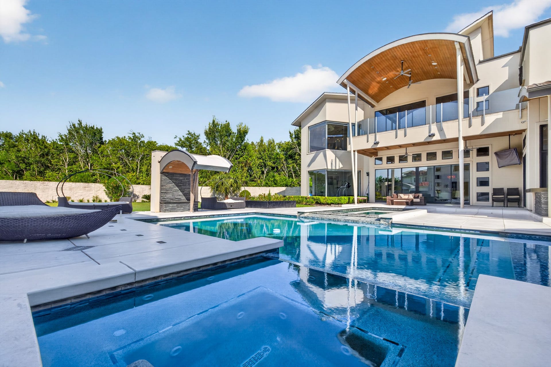 Expansive outdoor entertaining area features covered seating and a contemporary fire feature.