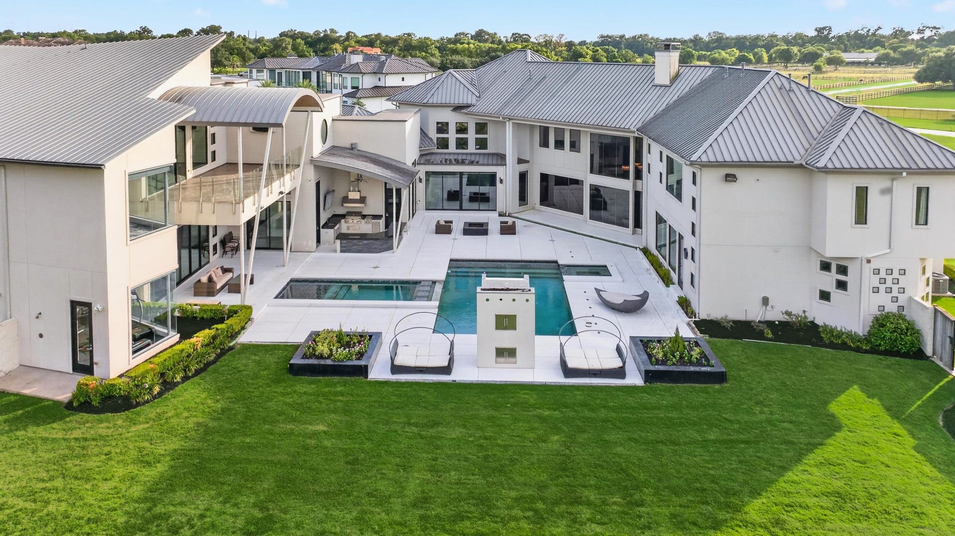 Resort-style backyard creates a private destination centered around the pool and expansive lawn.