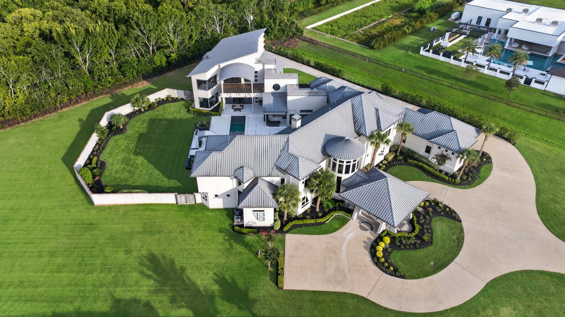 Aerial perspective showcases the scale, privacy and thoughtfully designed estate grounds.