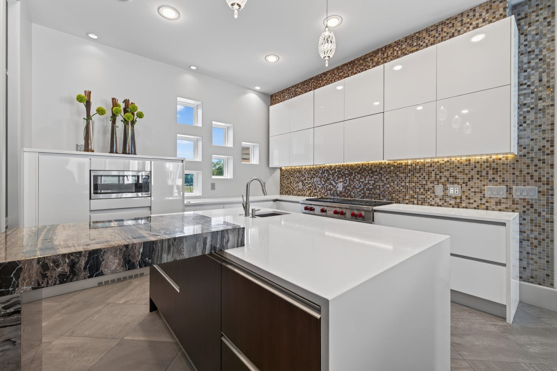 Professional-style cooking area features an impressive range and statement backsplash.