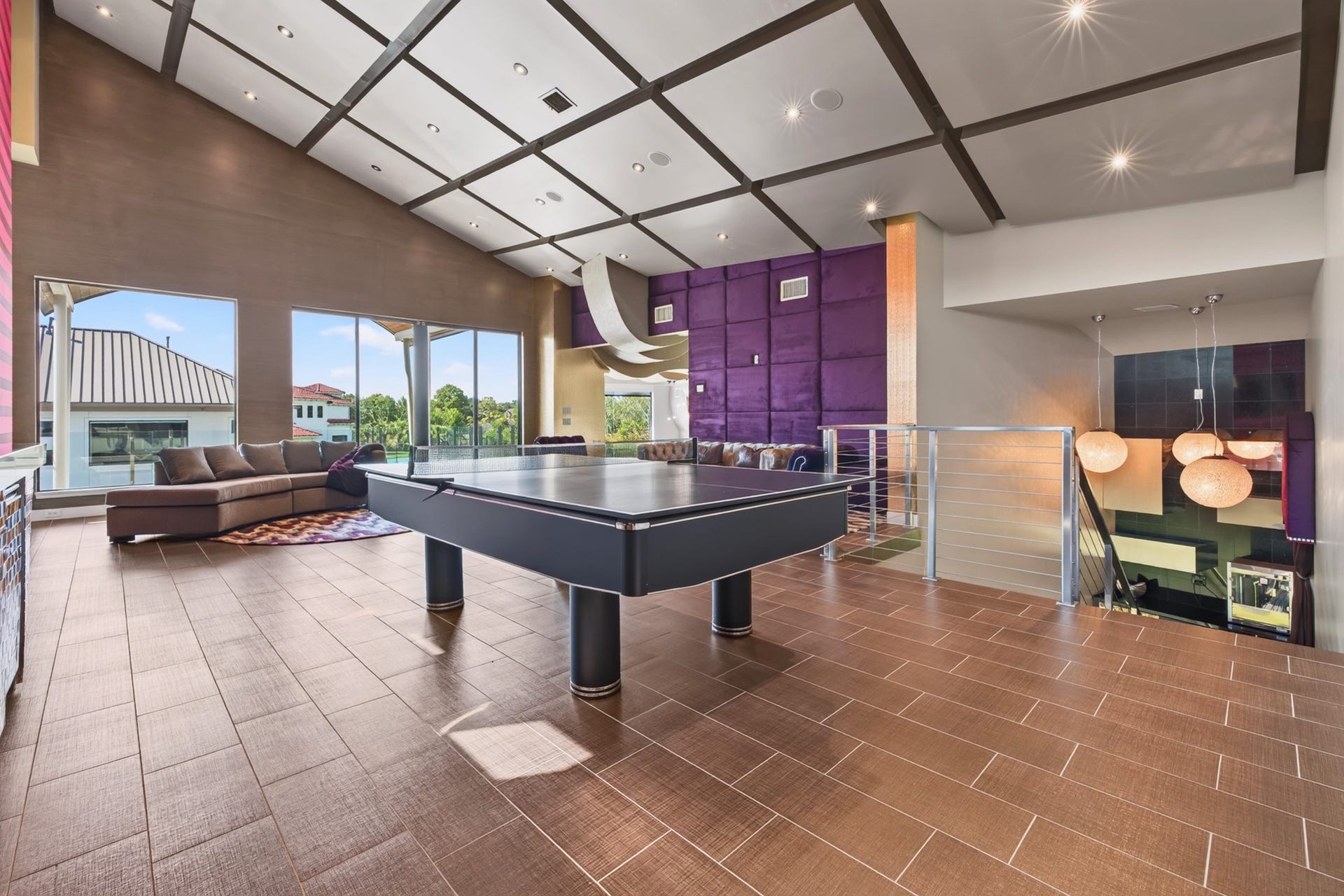 Custom entertainment space offers dramatic architectural detailing and built-in media features.