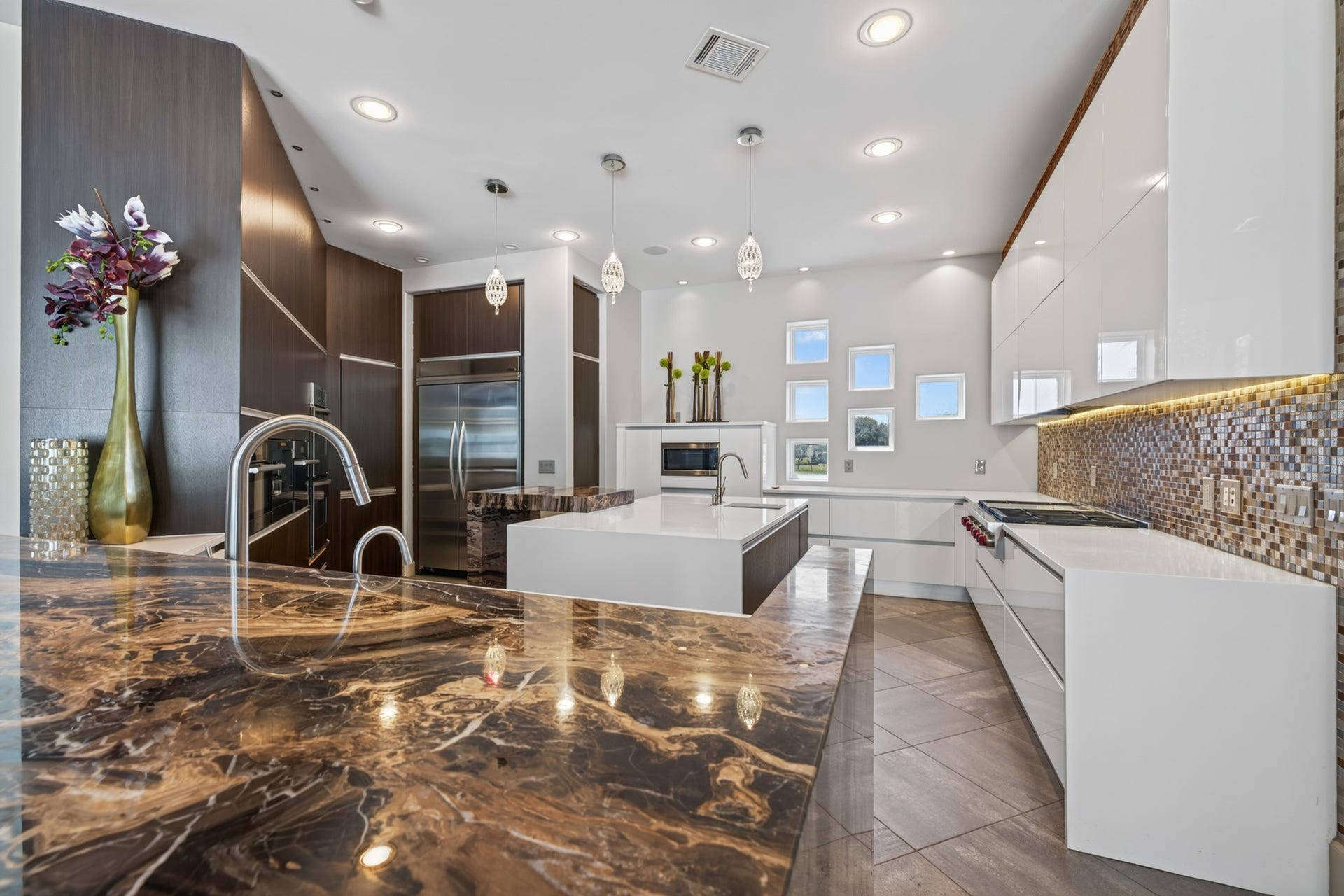 Expansive chefs kitchen offers multiple preparation areas, abundant cabinetry and premium appliances.