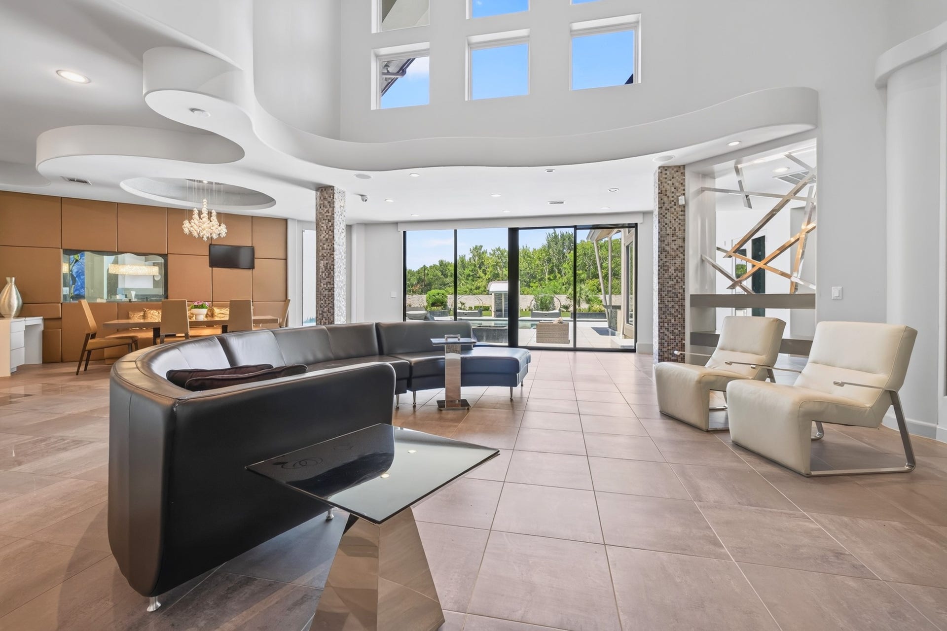 Additional living space features a fireplace, expansive windows and seamless access to the outdoors.