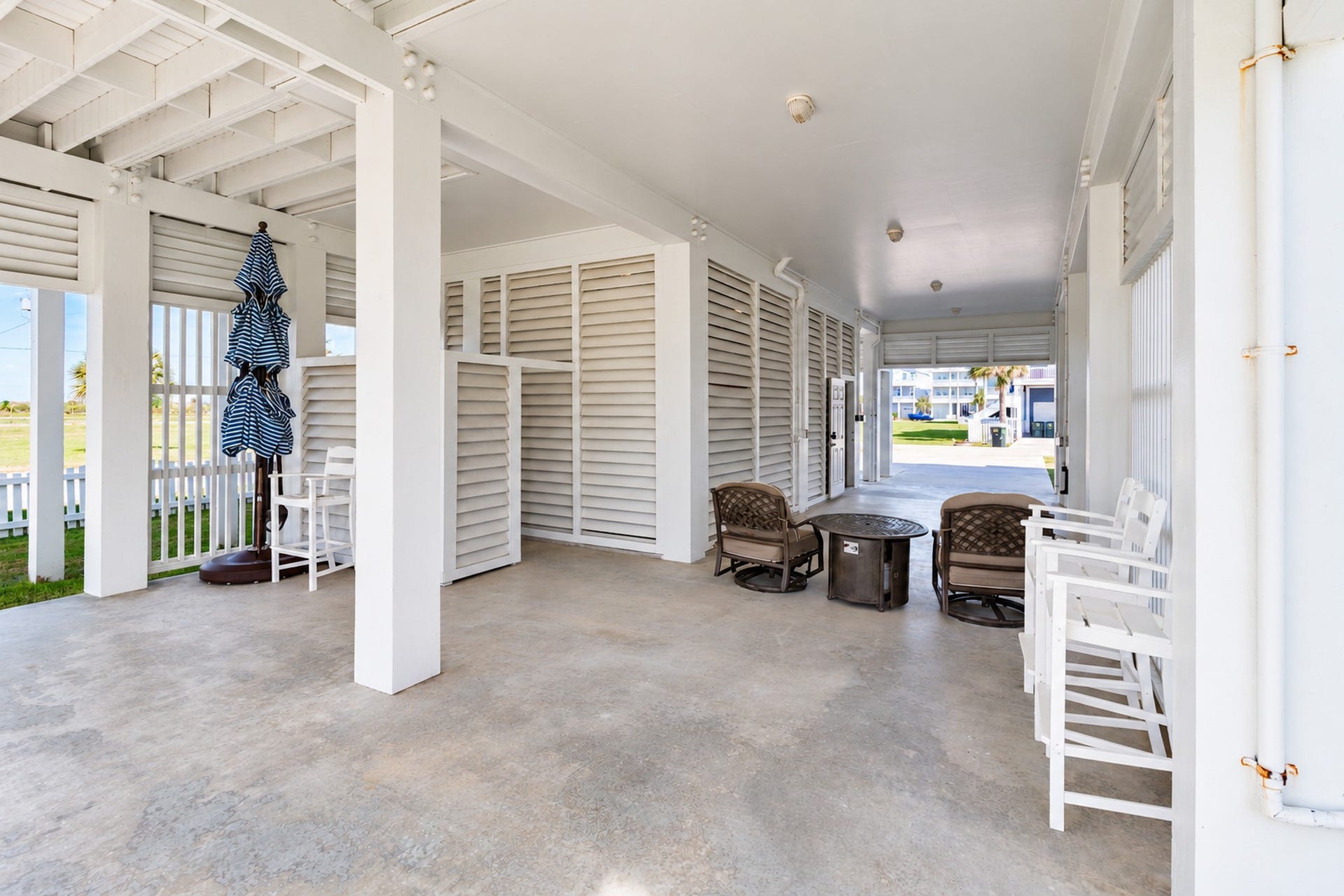 3802 Abalone Road, Galveston, TX 77554 Downstairs patios space includes covered parking, outdoor shower, enclosed garage space and enough room to still entertain guest.