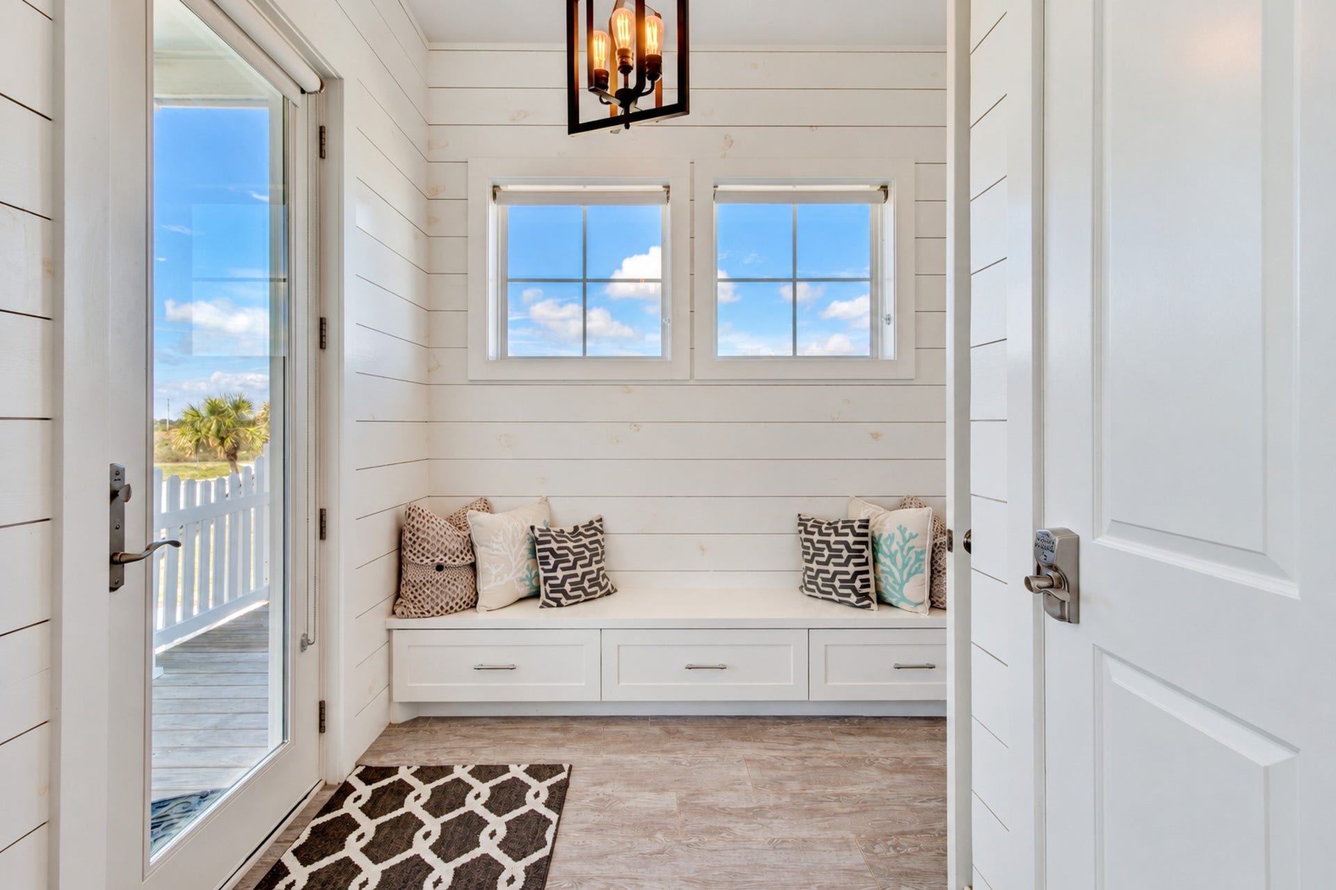 3802 Abalone Road, Galveston, TX 77554 When you enter the home from the west deck you enter into a sitting room. This area has shiplap accent walls, 1/2 bath and built-in storage.