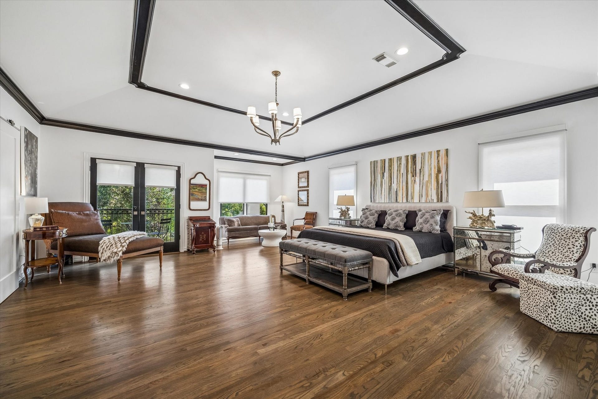 Spacious primary suite with sitting area and private balcony.