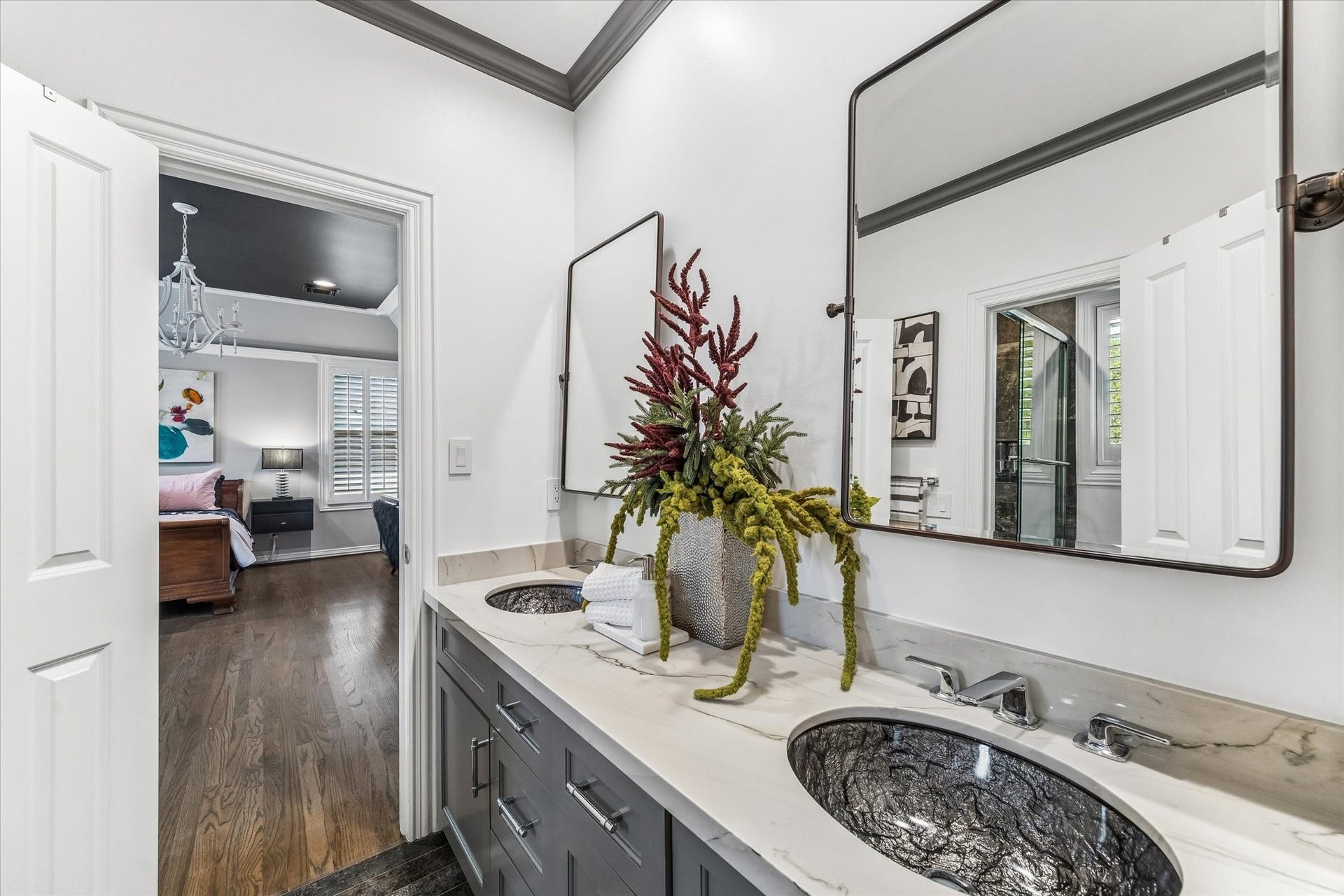Hollywood bathroom with Carrara quartzite countertop, dual sinks, custom cabinetry, and Italian tile flooring.