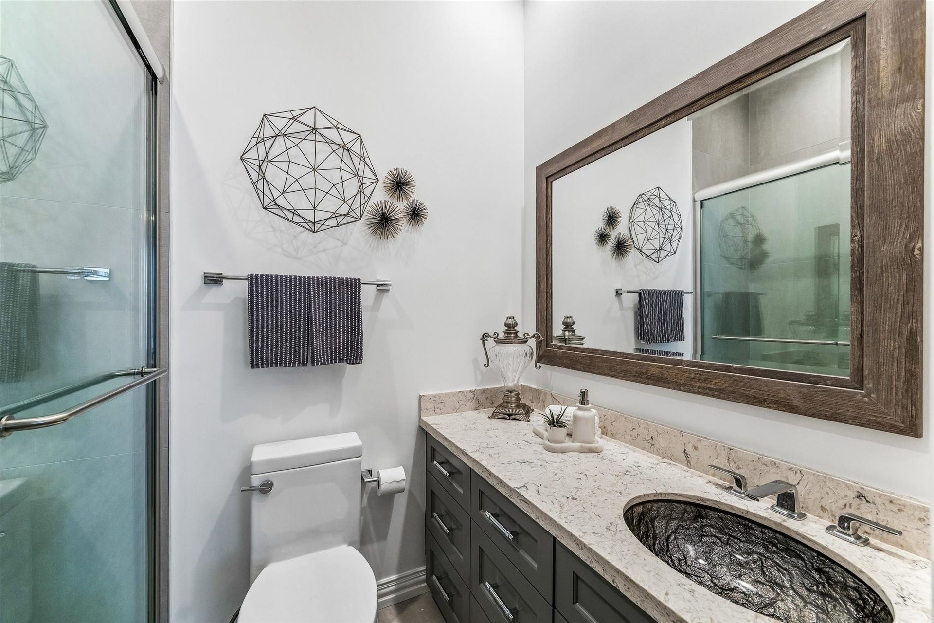 Beautiful ensuite bathroom with Le Blanc quartzite countertop and custom cabinetry.
