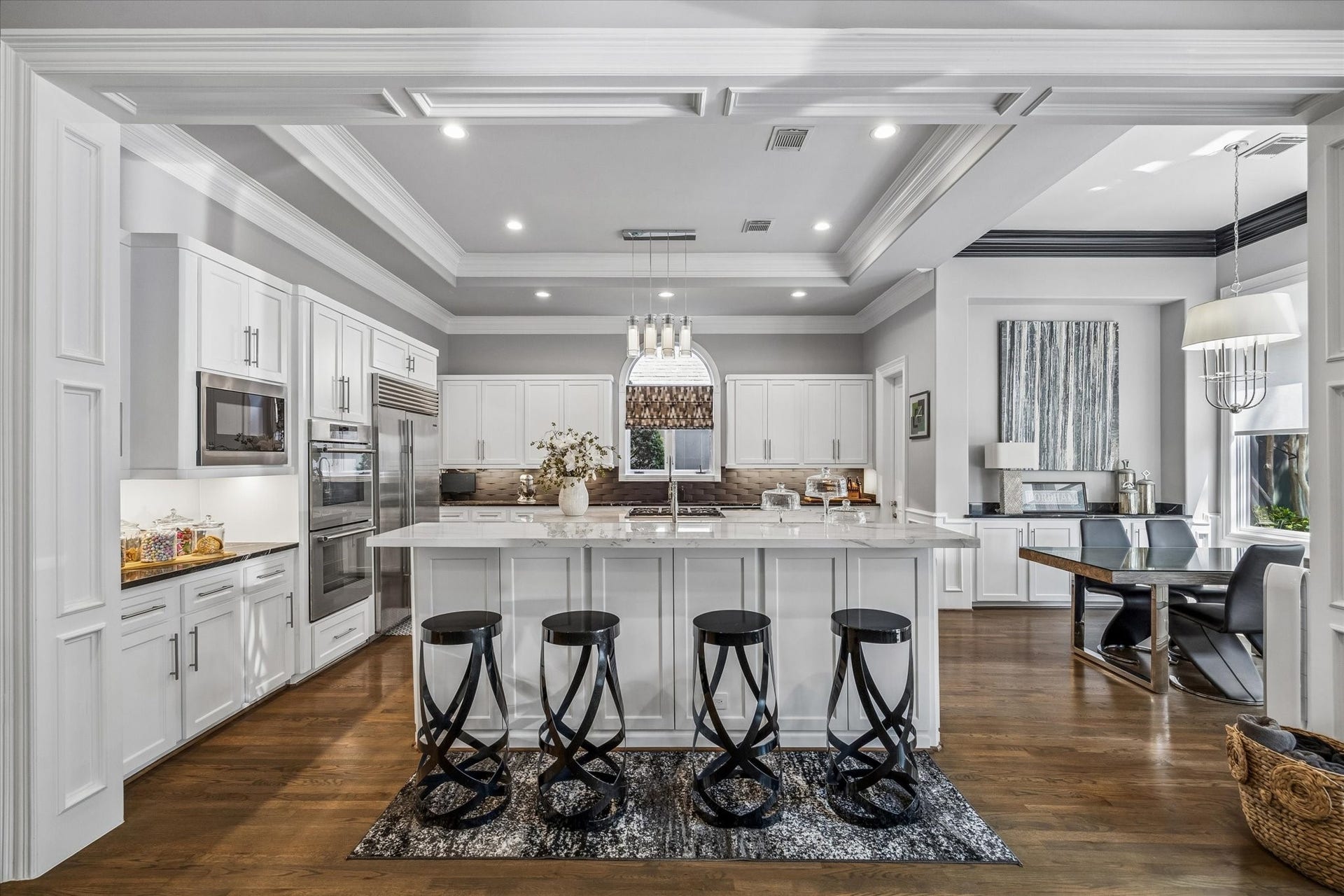 The kitchen was thoughtfully renovated with custom cabinetry, designer finishes, and Italian tile 3D backsplash.