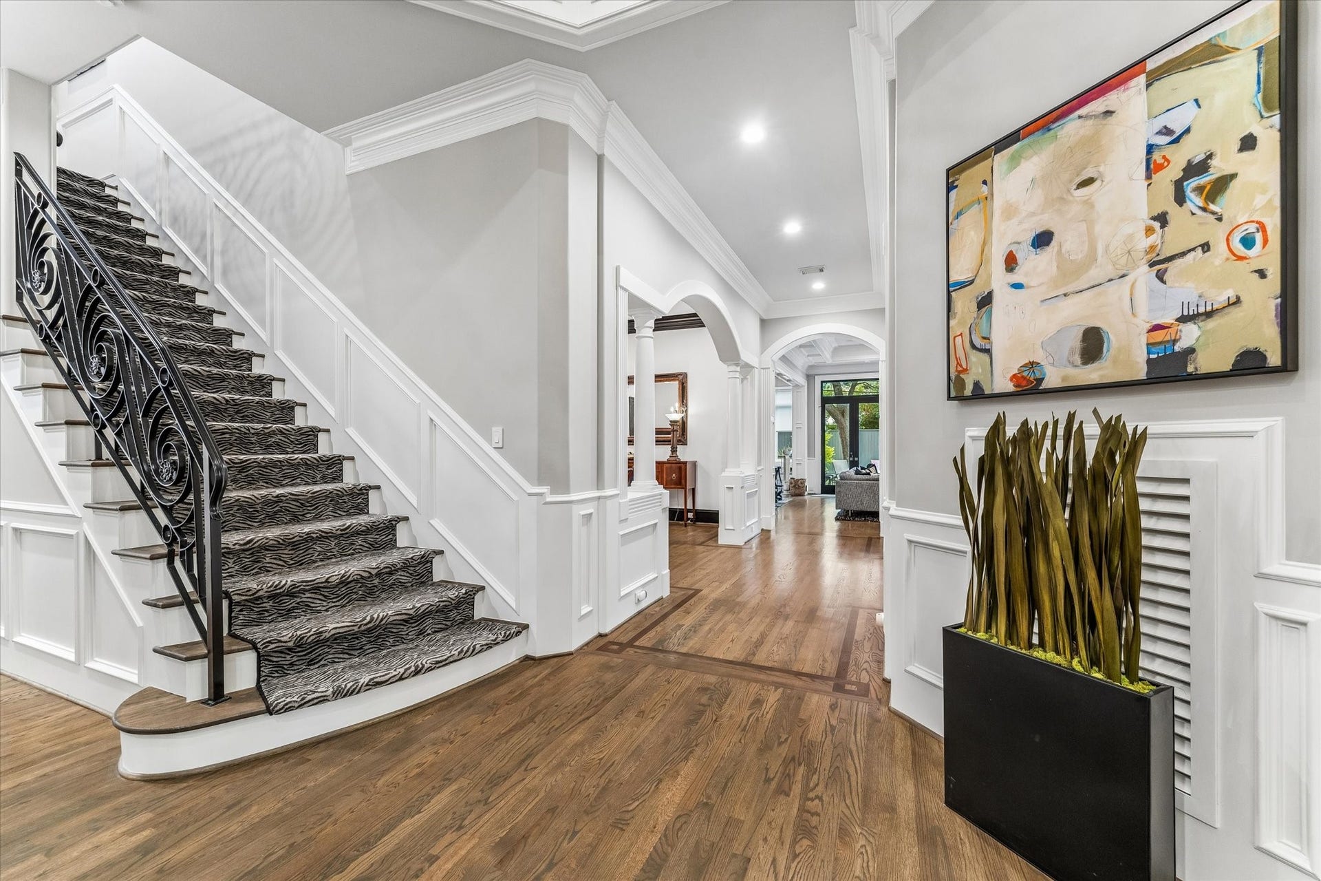 Stylishly carpeted staircase with decorative metal railing.