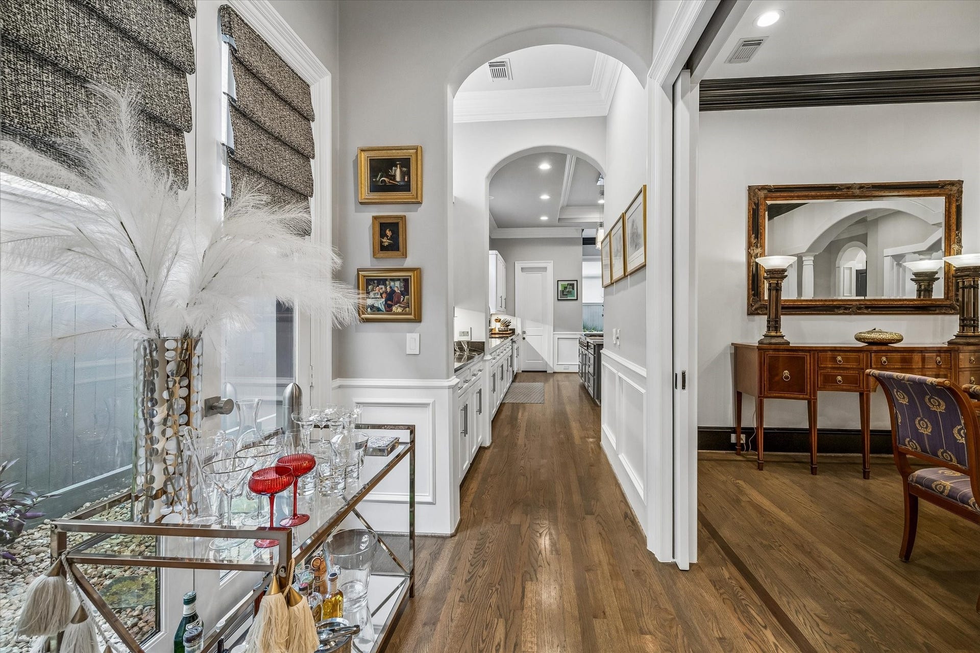 Just off the butler's pantry and outside the dining room, this nook is an ideal spot for a bar cart, with custom window treatments adding a finishing touch.