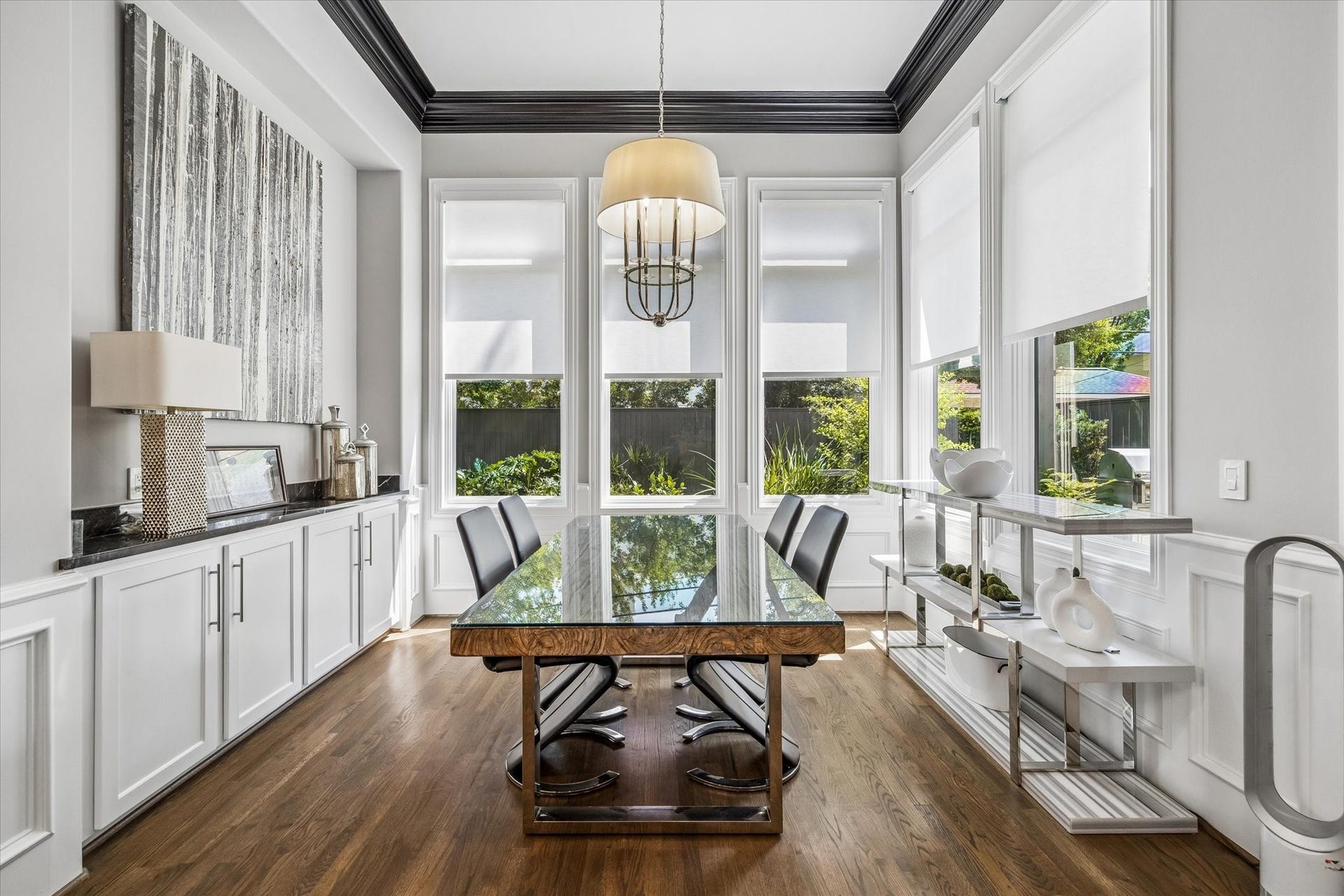 This light filled breakfast area offers beautiful backyard views and features custom electronic retractable roller shades and a built-in buffet.