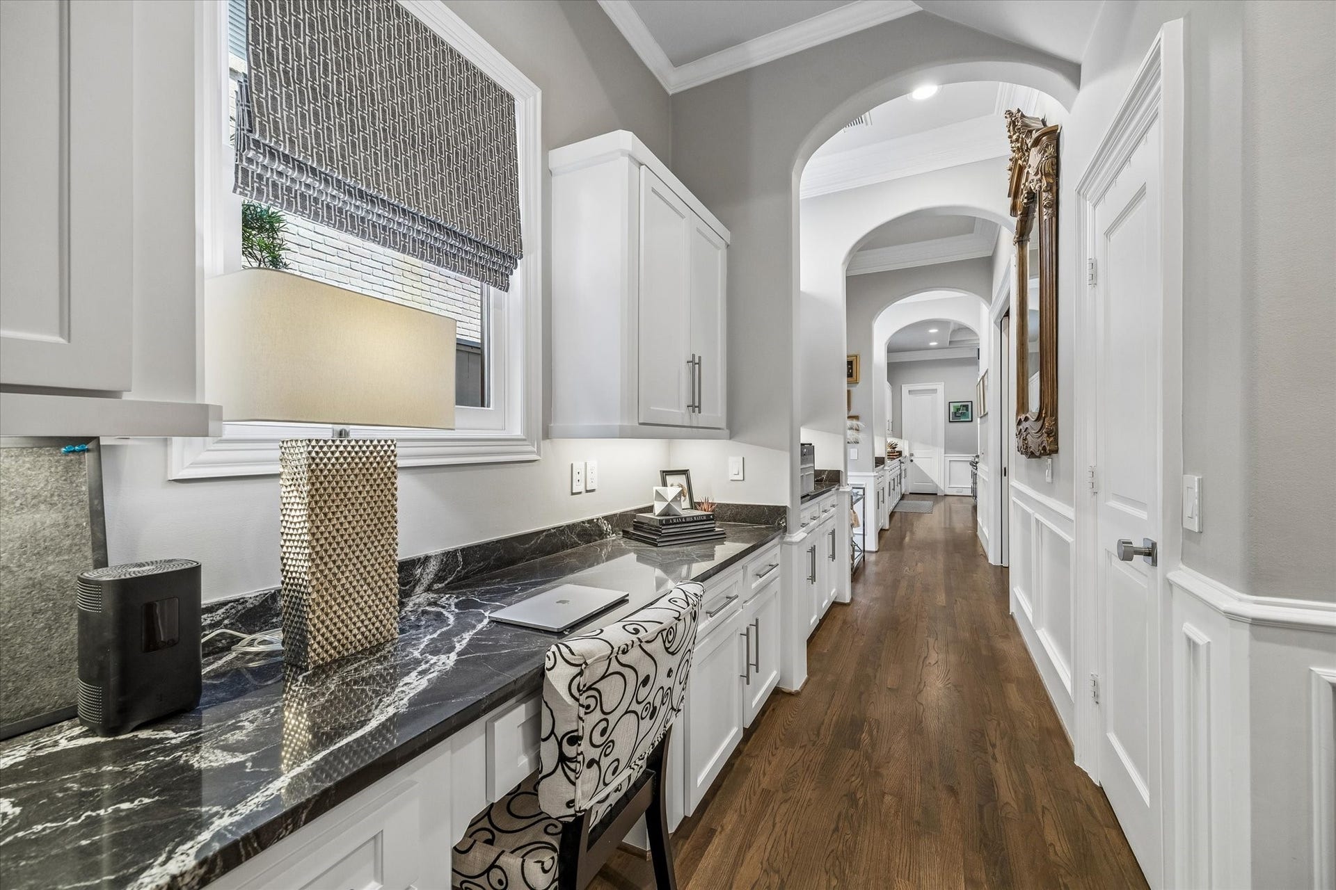 Another view of the built-in desk area, with a large storage closet behind the door to the right.