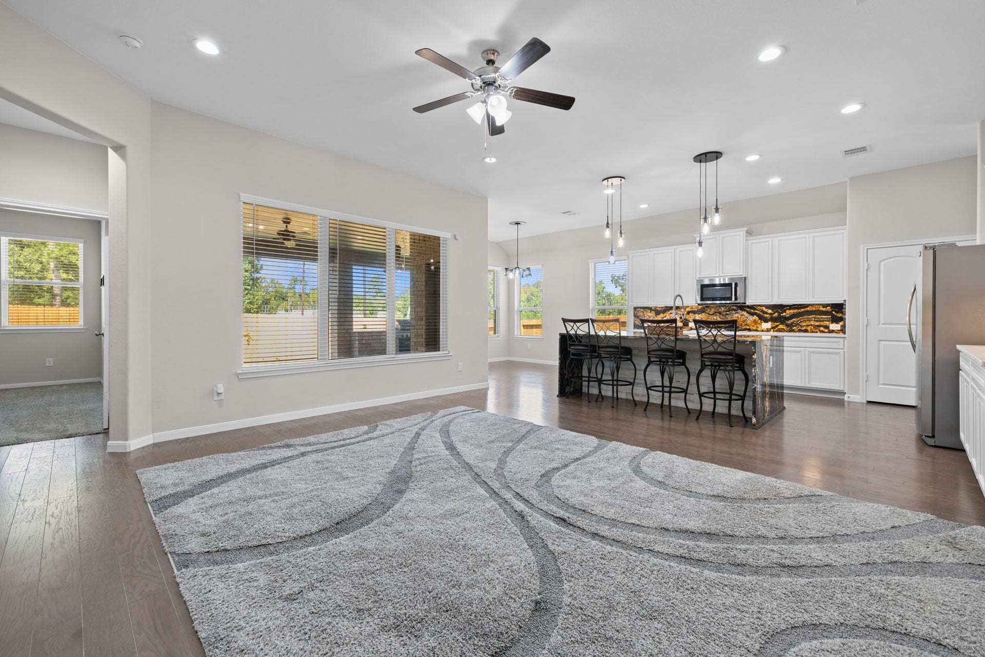 25615 Pinyon Hill Trail, Tomball, TX 77375 Looking towards the kitchen you can see the wood floors and open plan