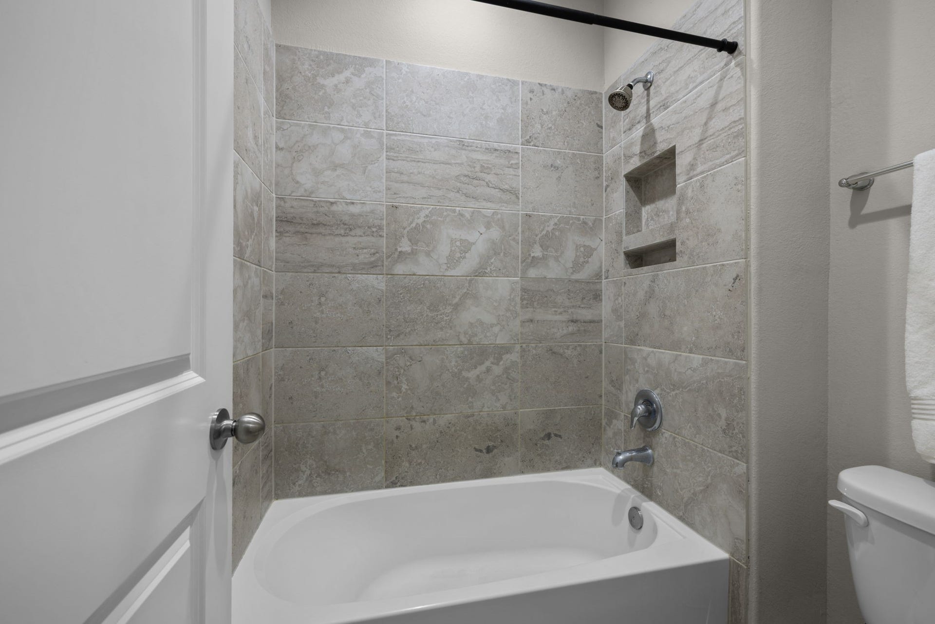 25615 Pinyon Hill Trail, Tomball, TX 77375 This bathroom has a tub/shower combo with full tile surround