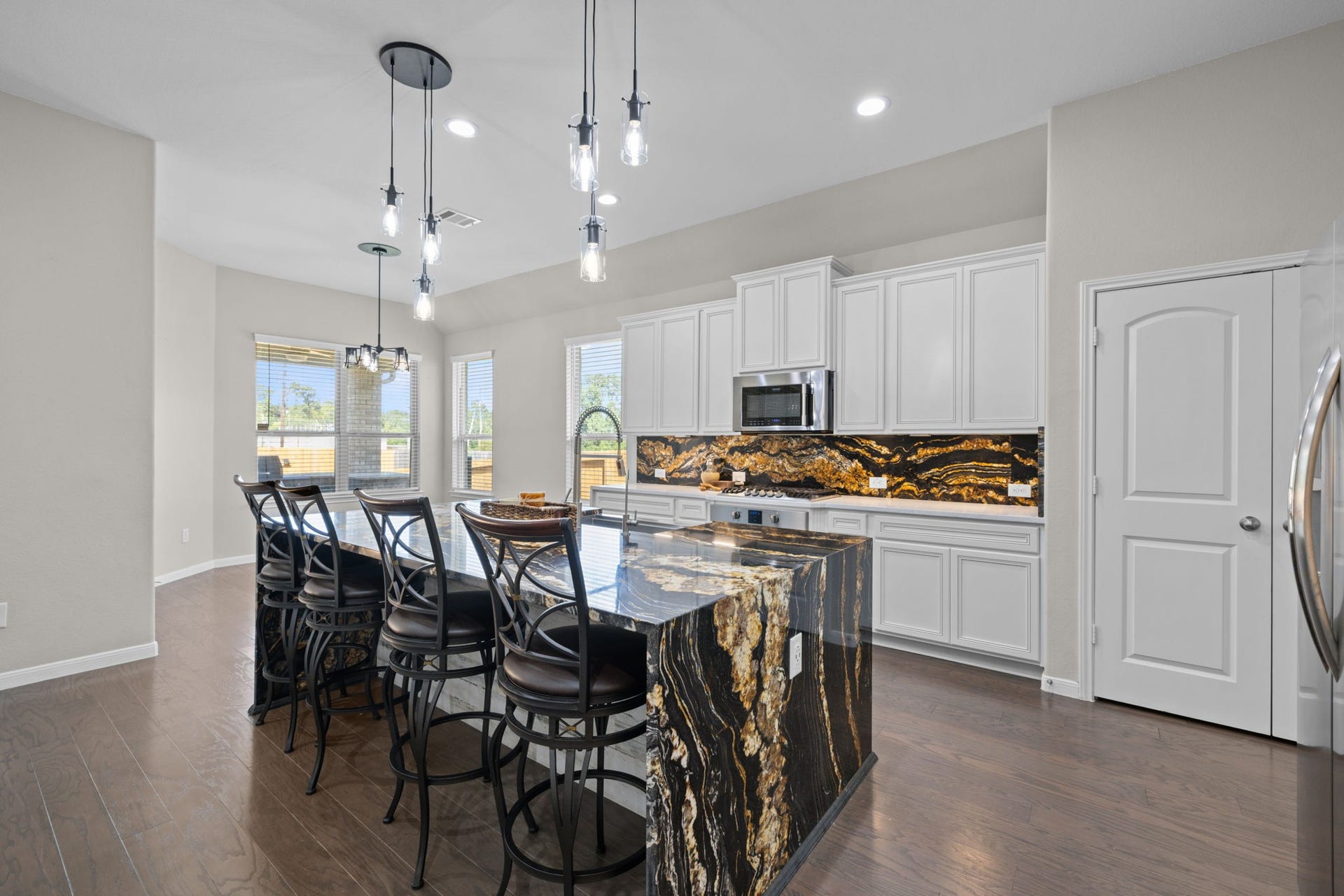 25615 Pinyon Hill Trail, Tomball, TX 77375 The large island will hold bar stools for informal dining