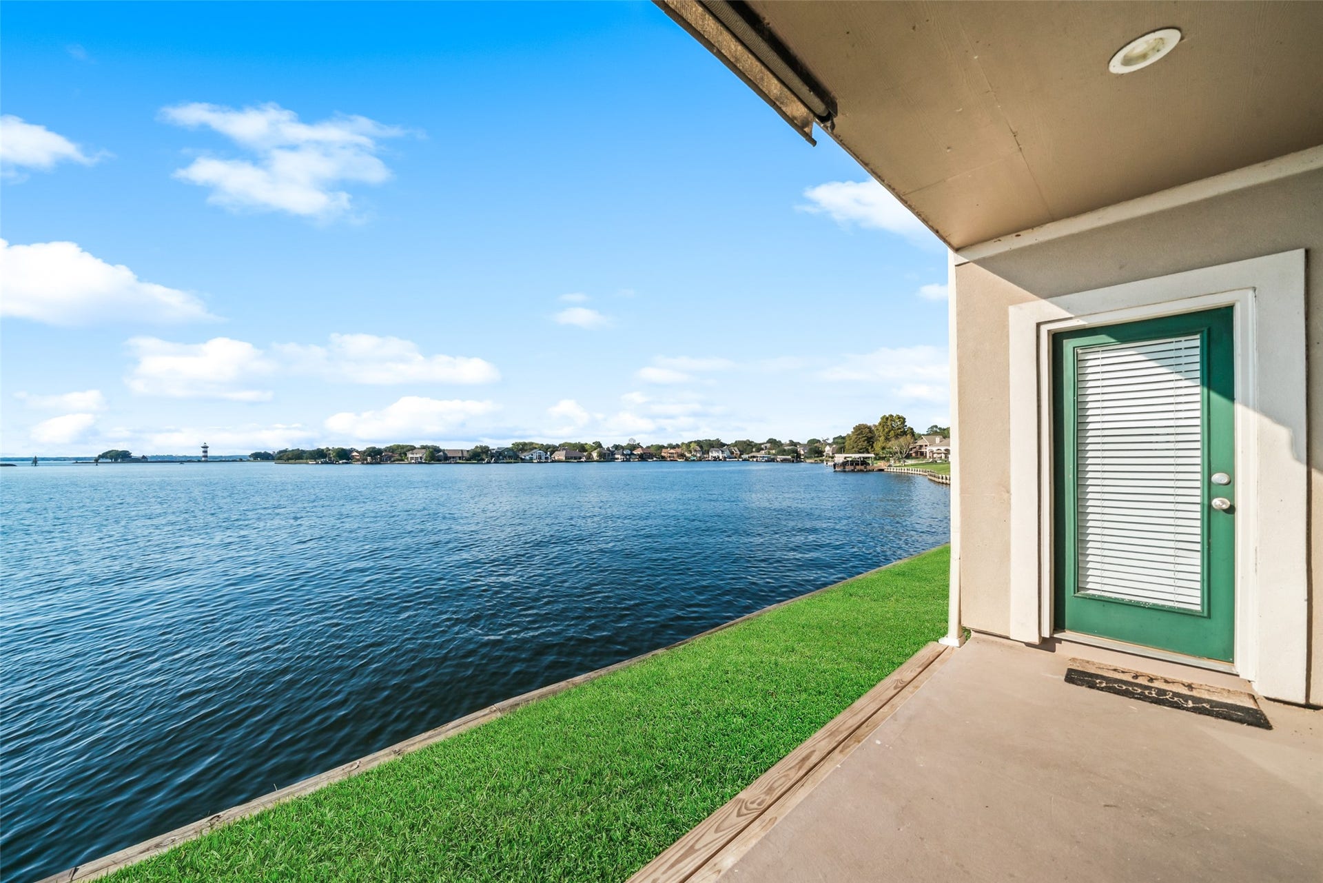 7037 Kingston Cove, #114, Willis, TX 77318 Covered patio overlooking the lake, with space to relax and enjoy expansive water views.
