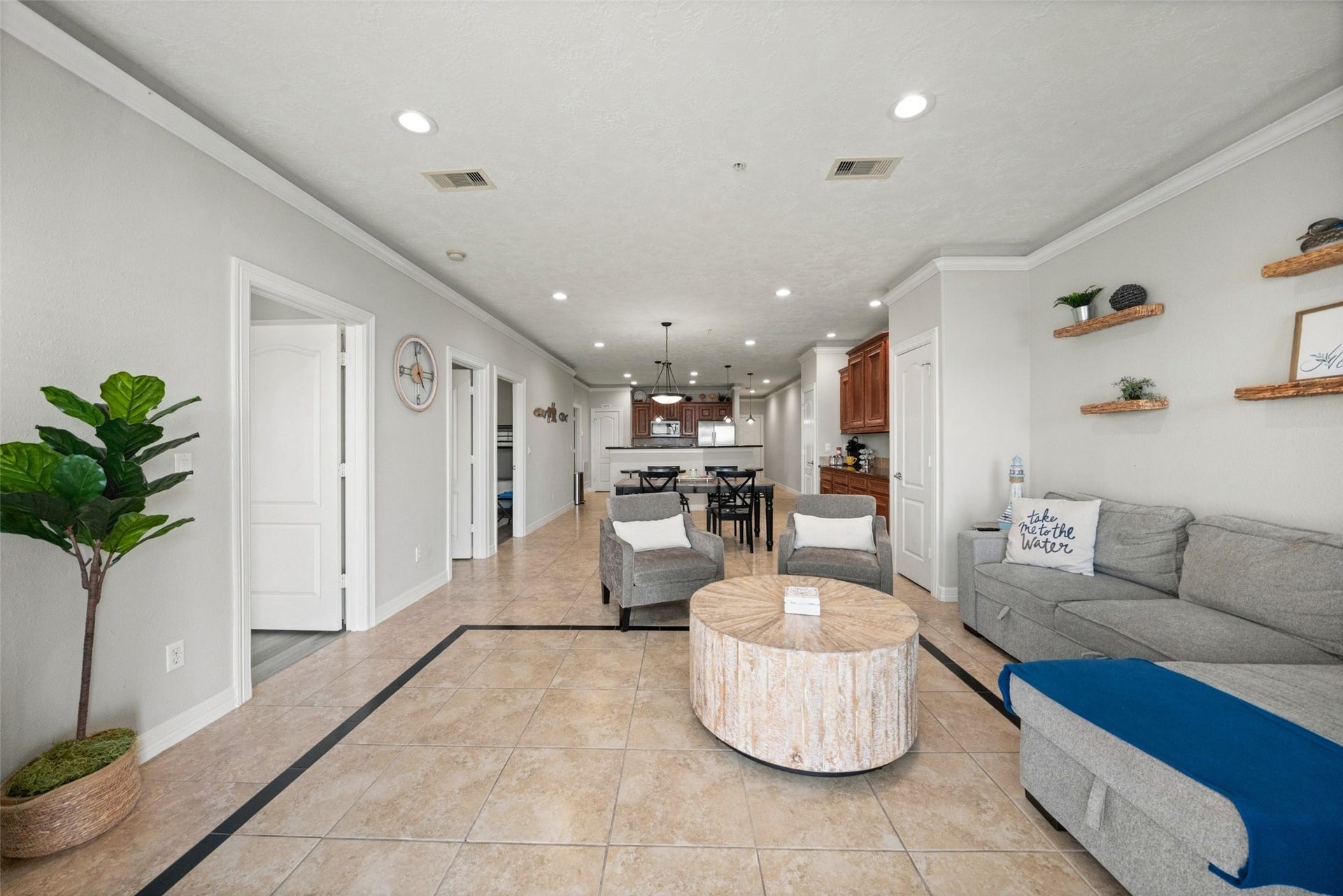7037 Kingston Cove, #114, Willis, TX 77318 Bright, open living area with recessed lighting, wood-look flooring, and a seamless connection to the kitchen