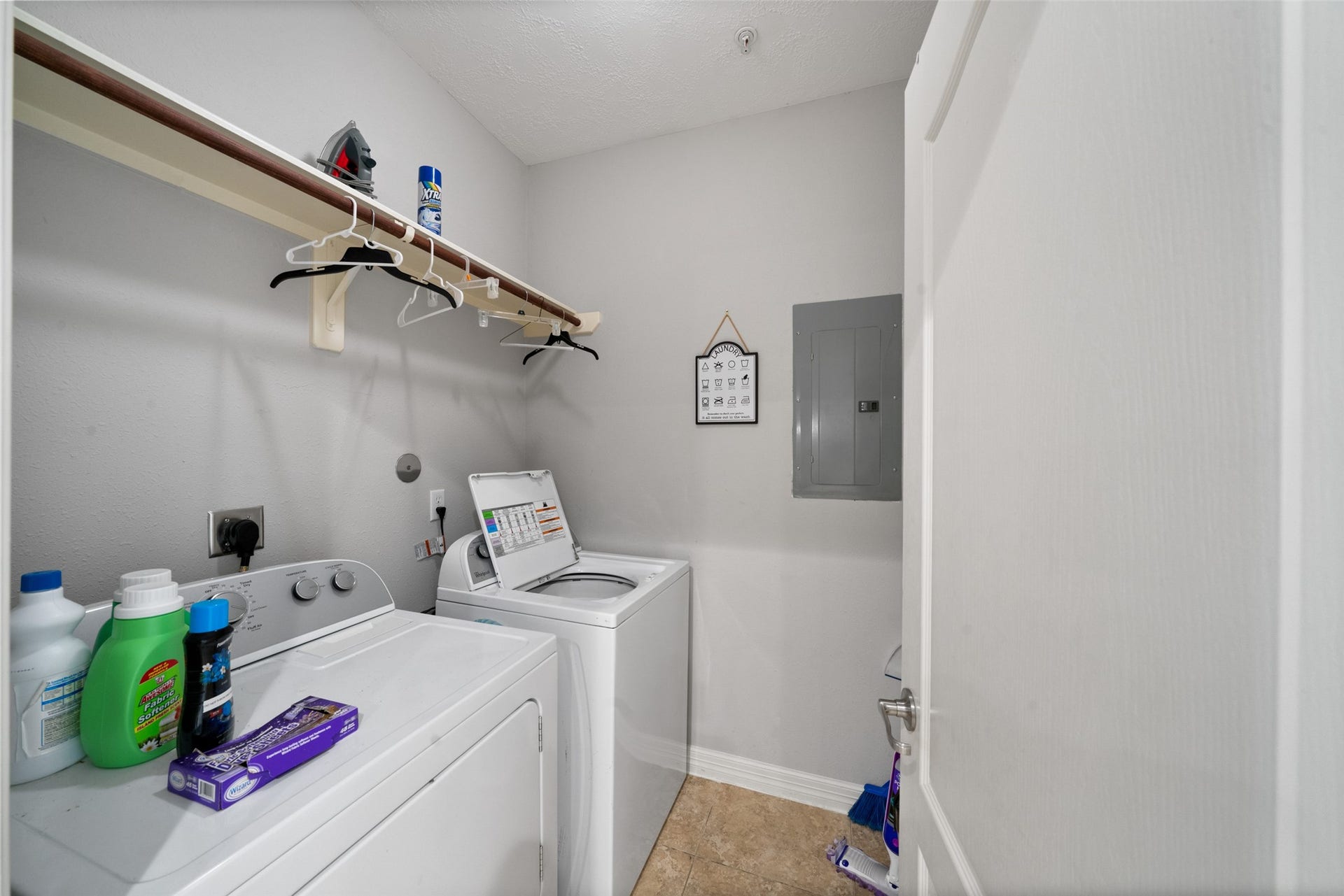 7037 Kingston Cove, #114, Willis, TX 77318 Dedicated laundry area accommodates a washer and dryer, with overhead shelving for everyday essentials.