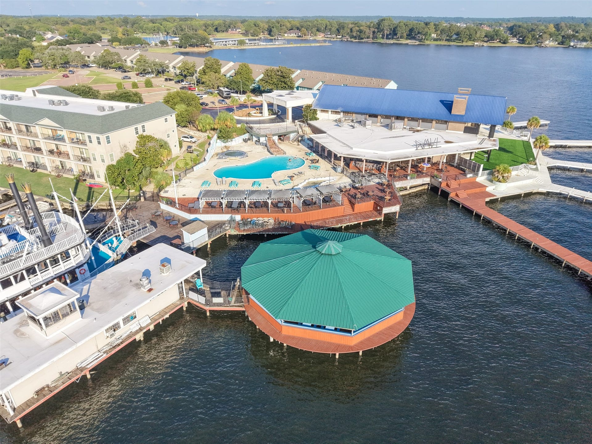7037 Kingston Cove, #114, Willis, TX 77318 Wide aerial view of the marina, boat slips, and neighboring waterfront facilities.