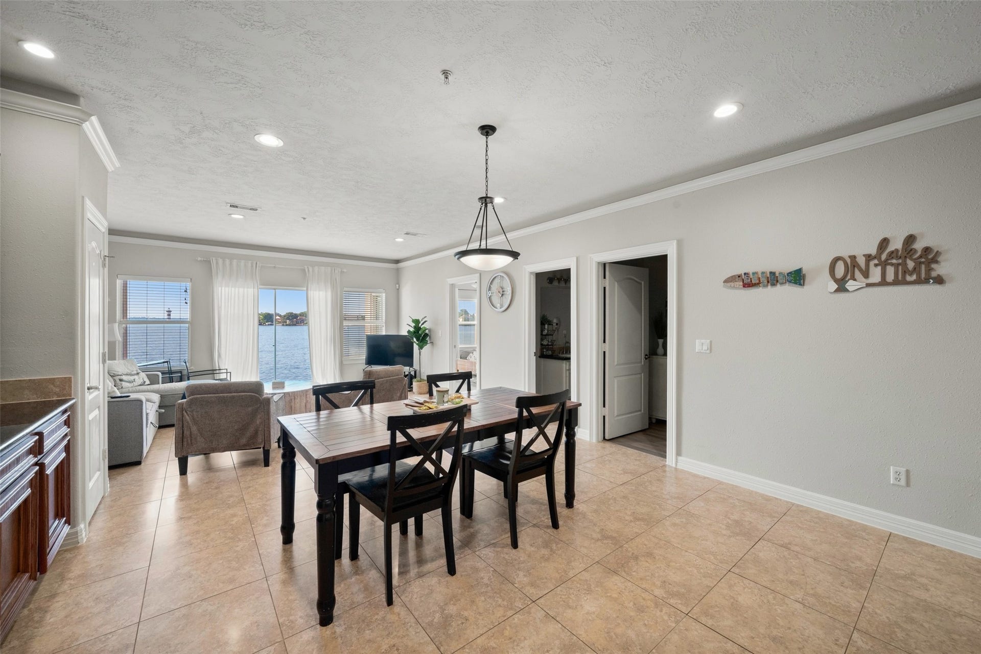 7037 Kingston Cove, #114, Willis, TX 77318 Dining area features wood-look flooring and recessed lighting, with an easy flow into the kitchen and living spaces.