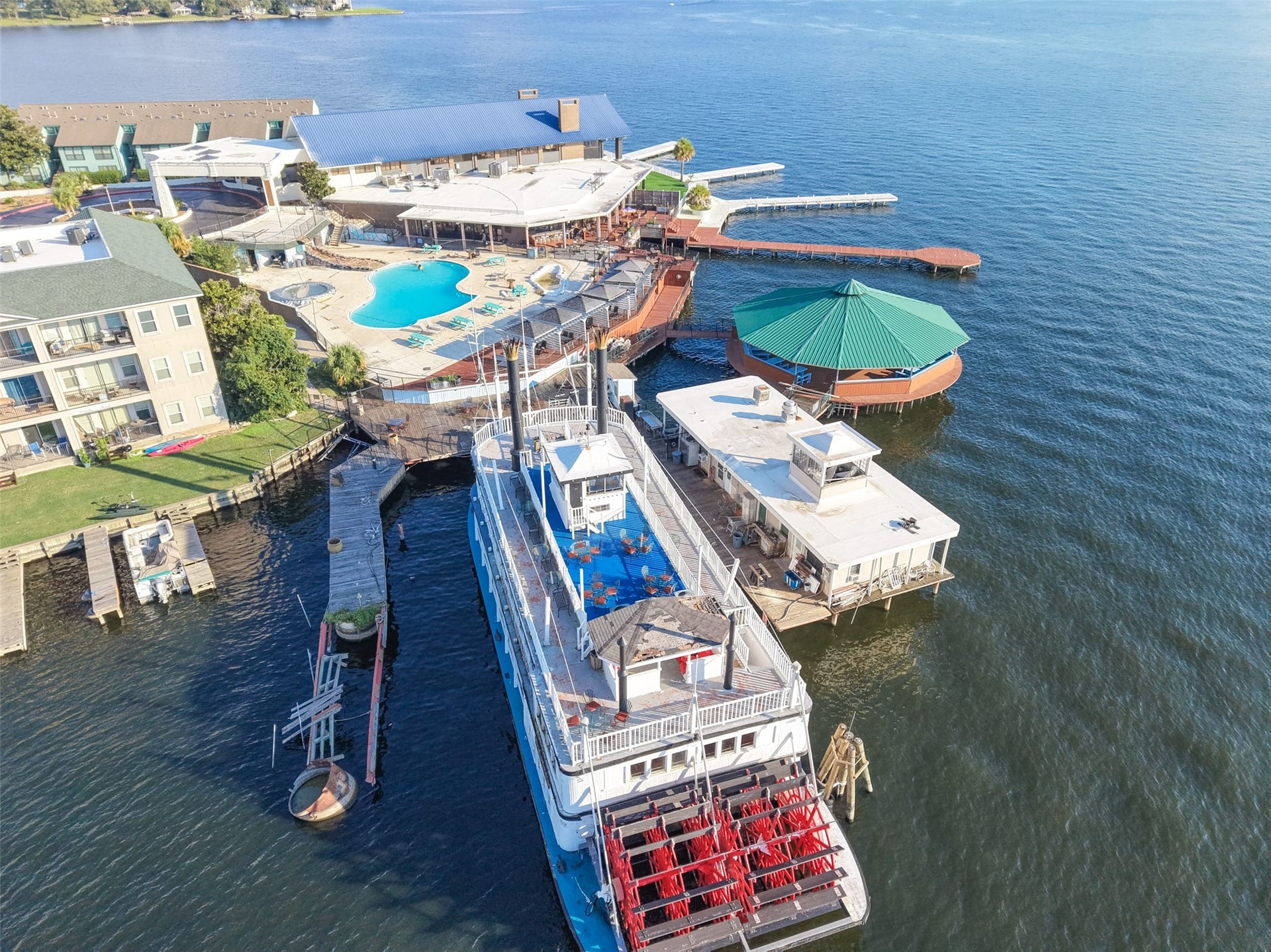 7037 Kingston Cove, #114, Willis, TX 77318 Aerial view showcases nearby marina facilities, docked boats, and waterfront gathering areas along the lake.