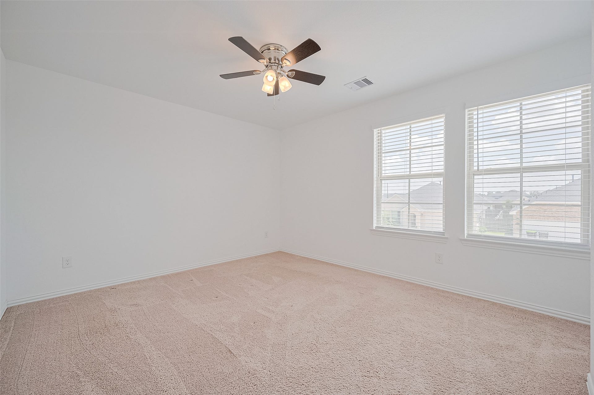 31326 Whitfield Court, Fulshear, TX 77441 Bright, spacious room with neutral carpeting and a ceiling fan.