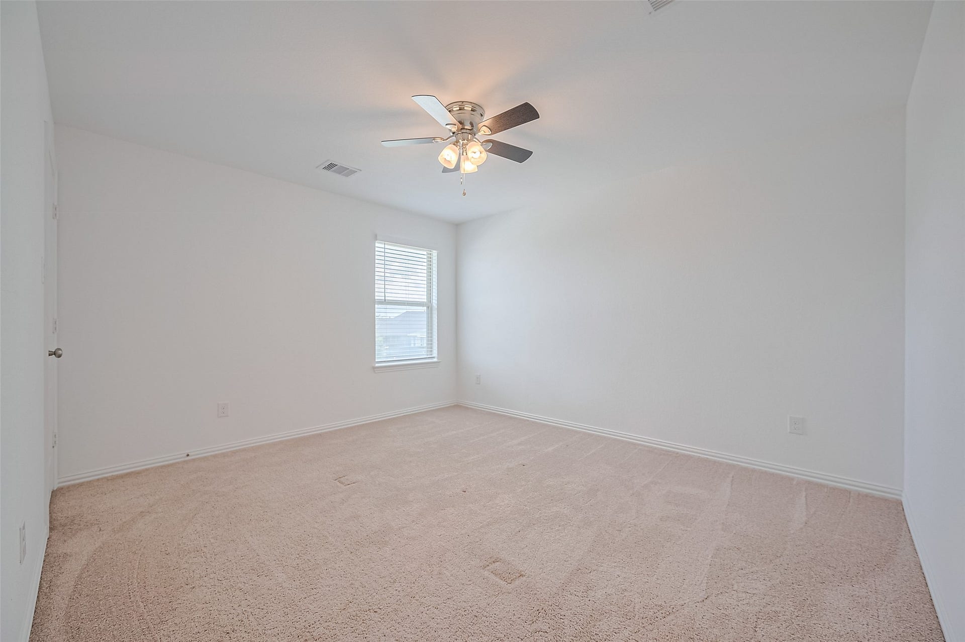 31326 Whitfield Court, Fulshear, TX 77441 Spacious bedroom with plush carpet and abundant natural light.