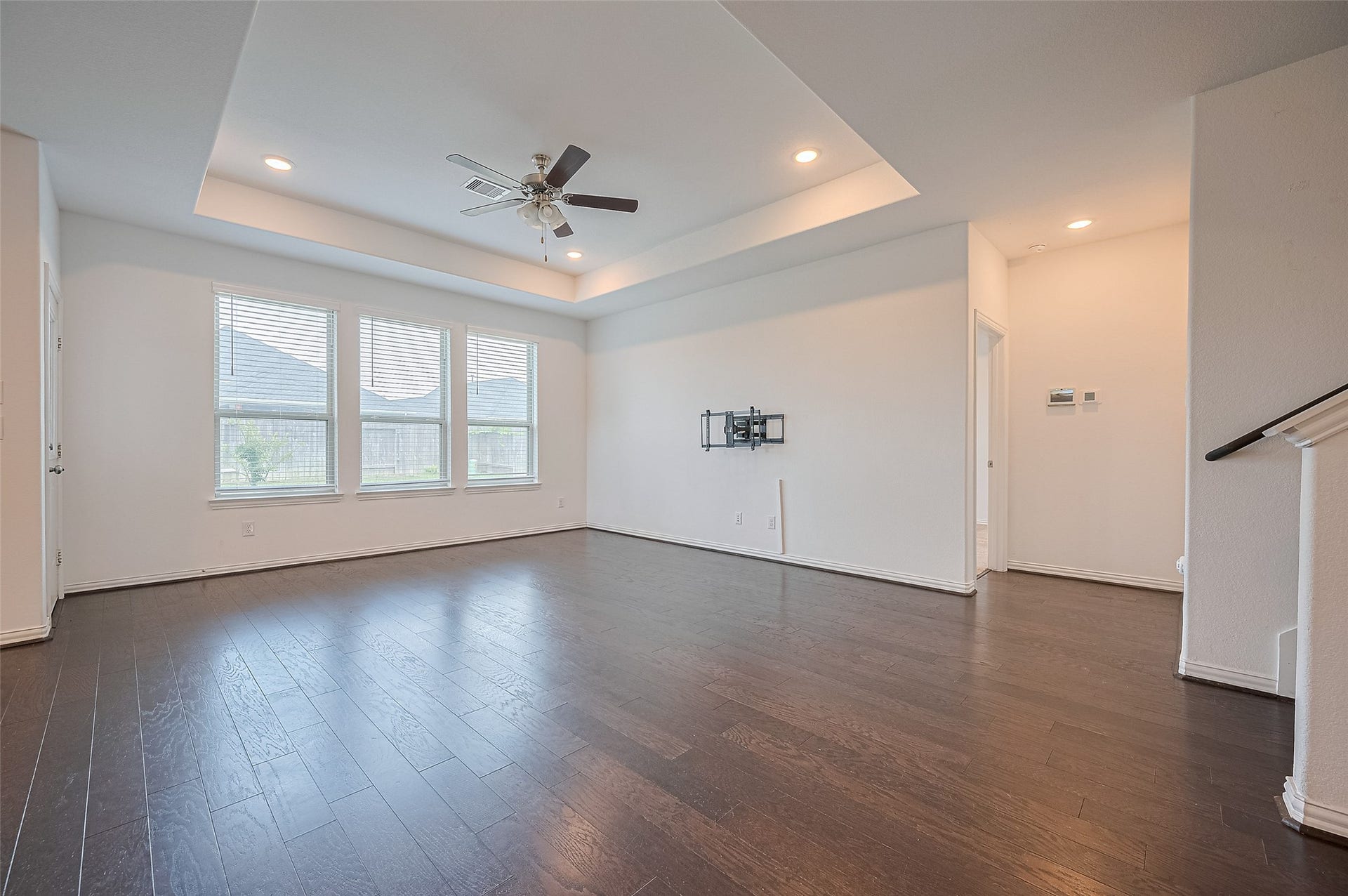 31326 Whitfield Court, Fulshear, TX 77441 Spacious living room features large windows and a tray ceiling.