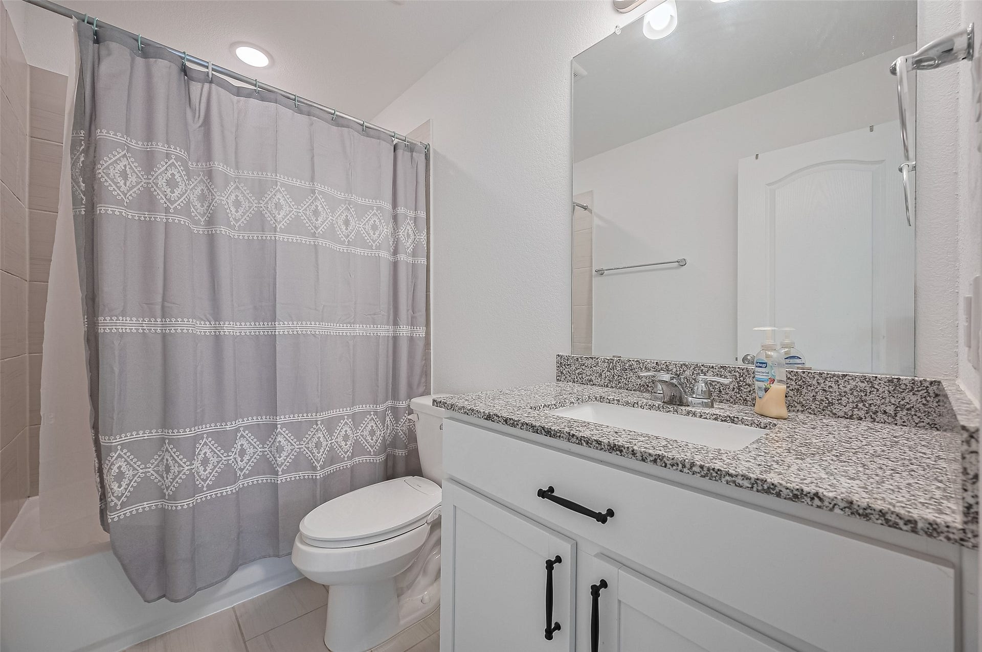 31326 Whitfield Court, Fulshear, TX 77441 Bathroom features a granite countertop, undermount sink, and white cabinetry.