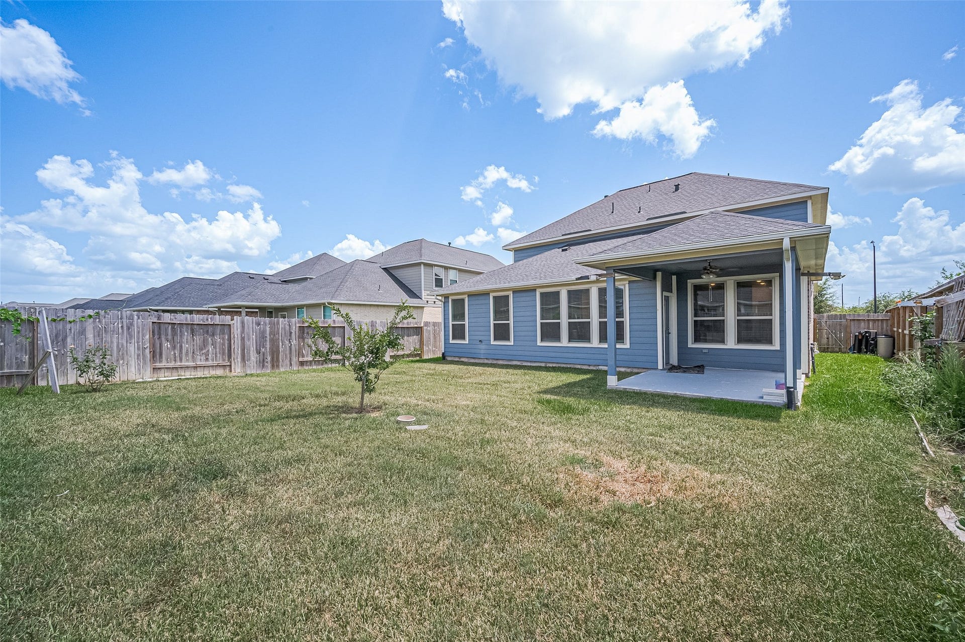 31326 Whitfield Court, Fulshear, TX 77441 Backyard featuring a lush lawn and wooden privacy fence.