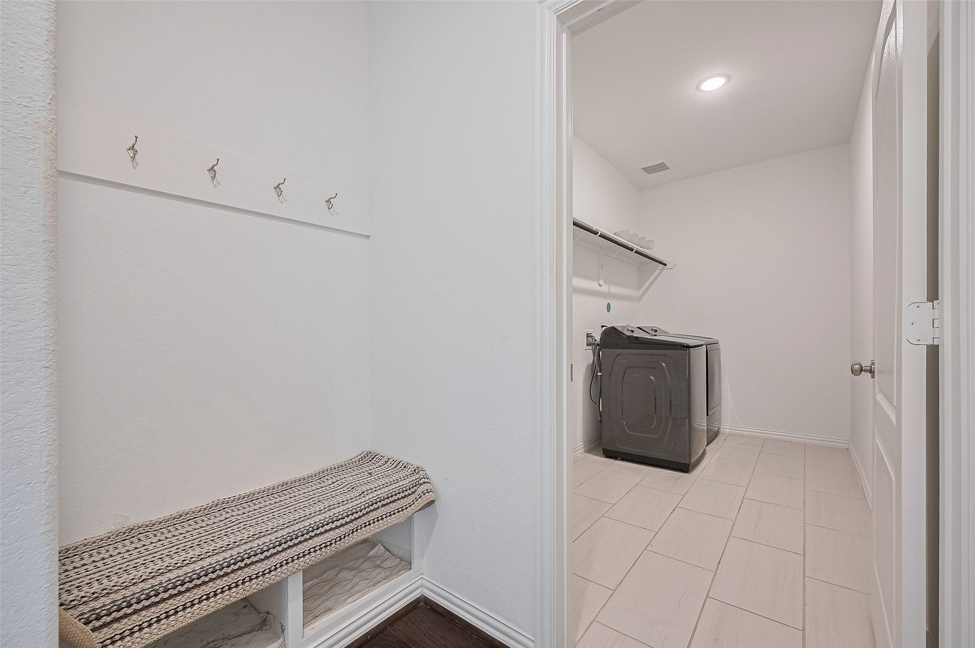 31326 Whitfield Court, Fulshear, TX 77441 Laundry room featuring a modern washer, open shelving, and an adjoining mudroom.